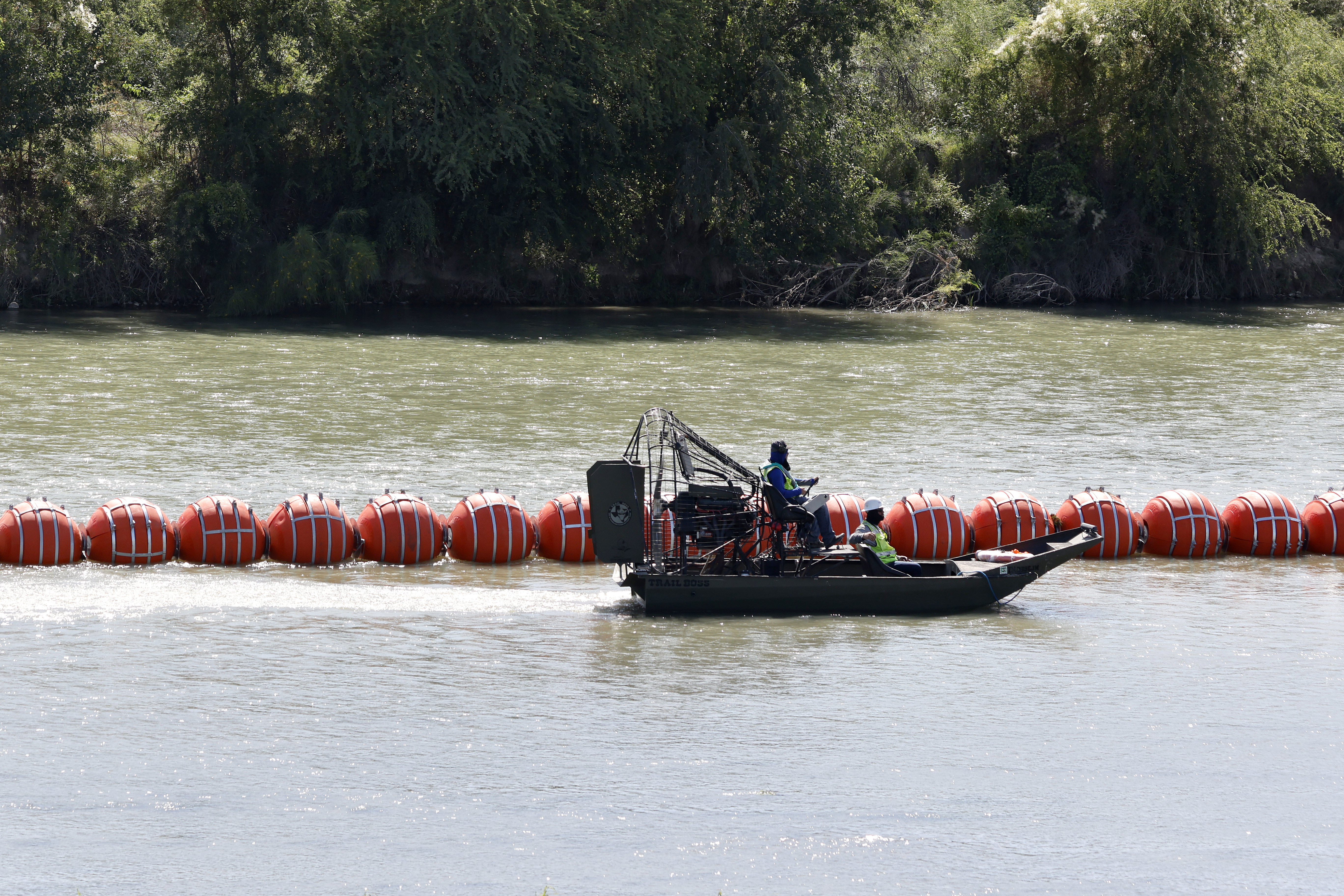 epa10744684 Workers fix buoys that were placed in the Rio Grande River