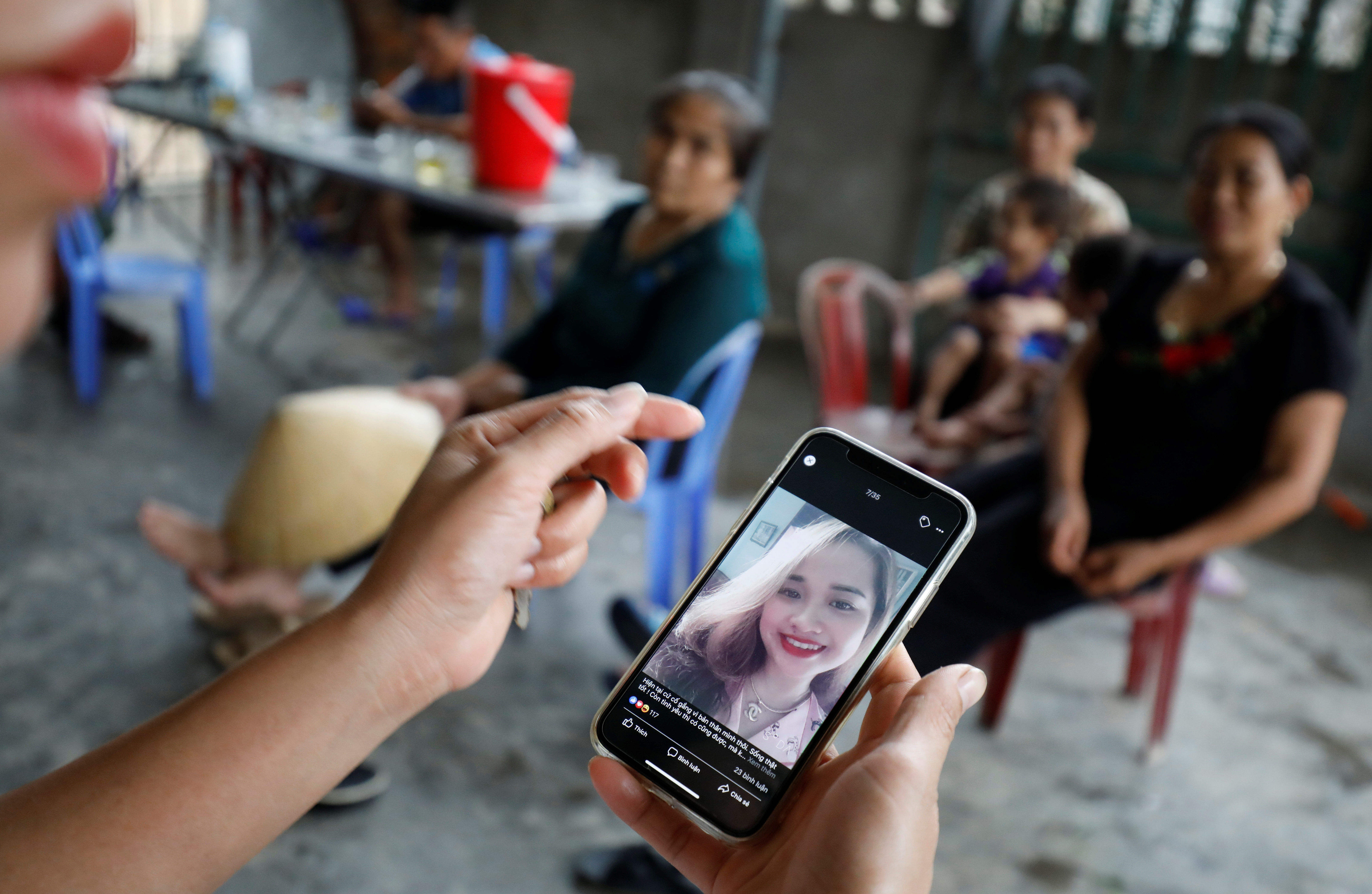 A relative looks at an image of Anna Bui Thi Nhung, a victim who was found dead in the back of British truck last month, at her home in Nghe An province, Vietnam October 26, 2019. Picture taken October 26, 2019. REUTERS/Kham