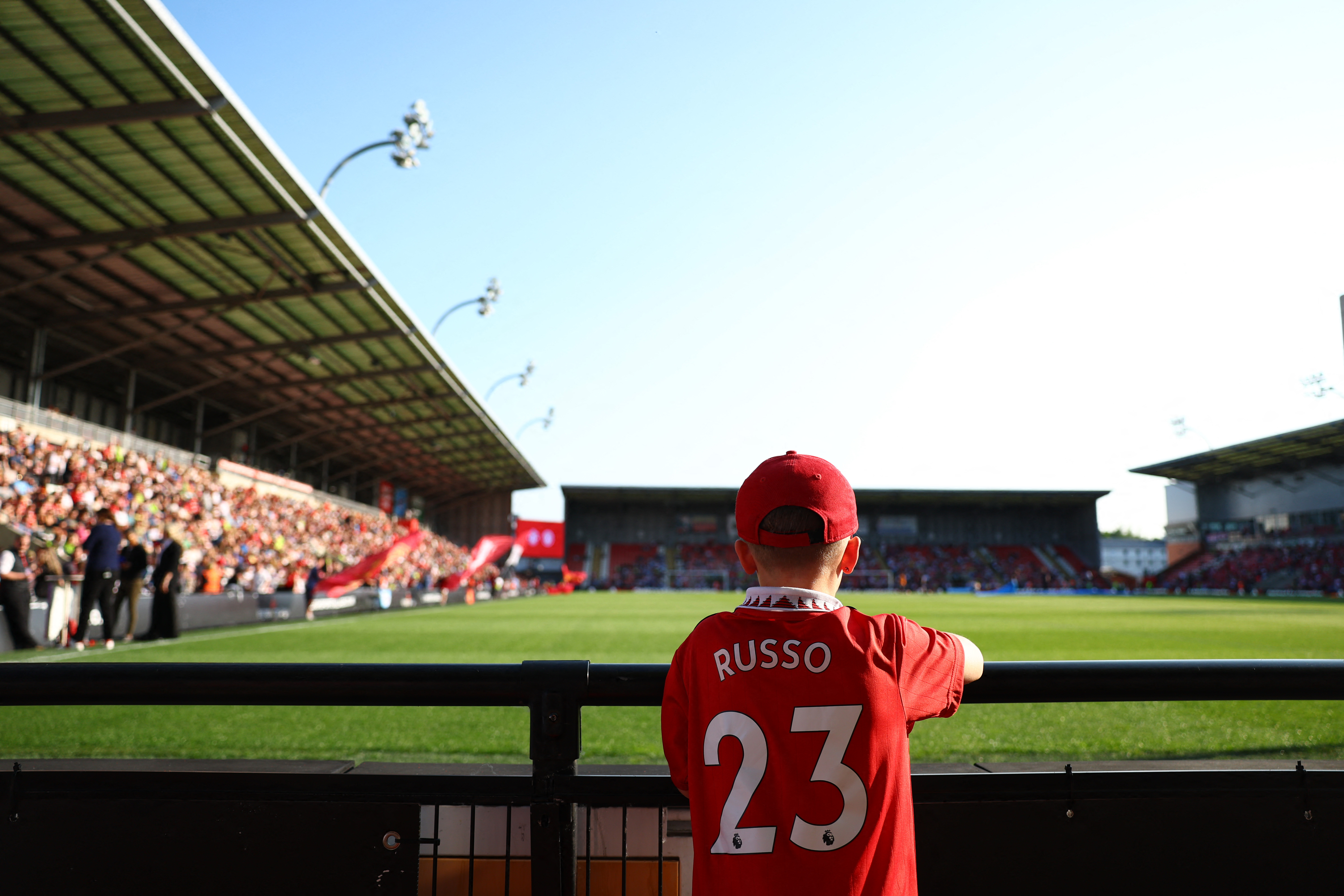 A fan stands near the pitch before a match between Manchester United and Manchester City