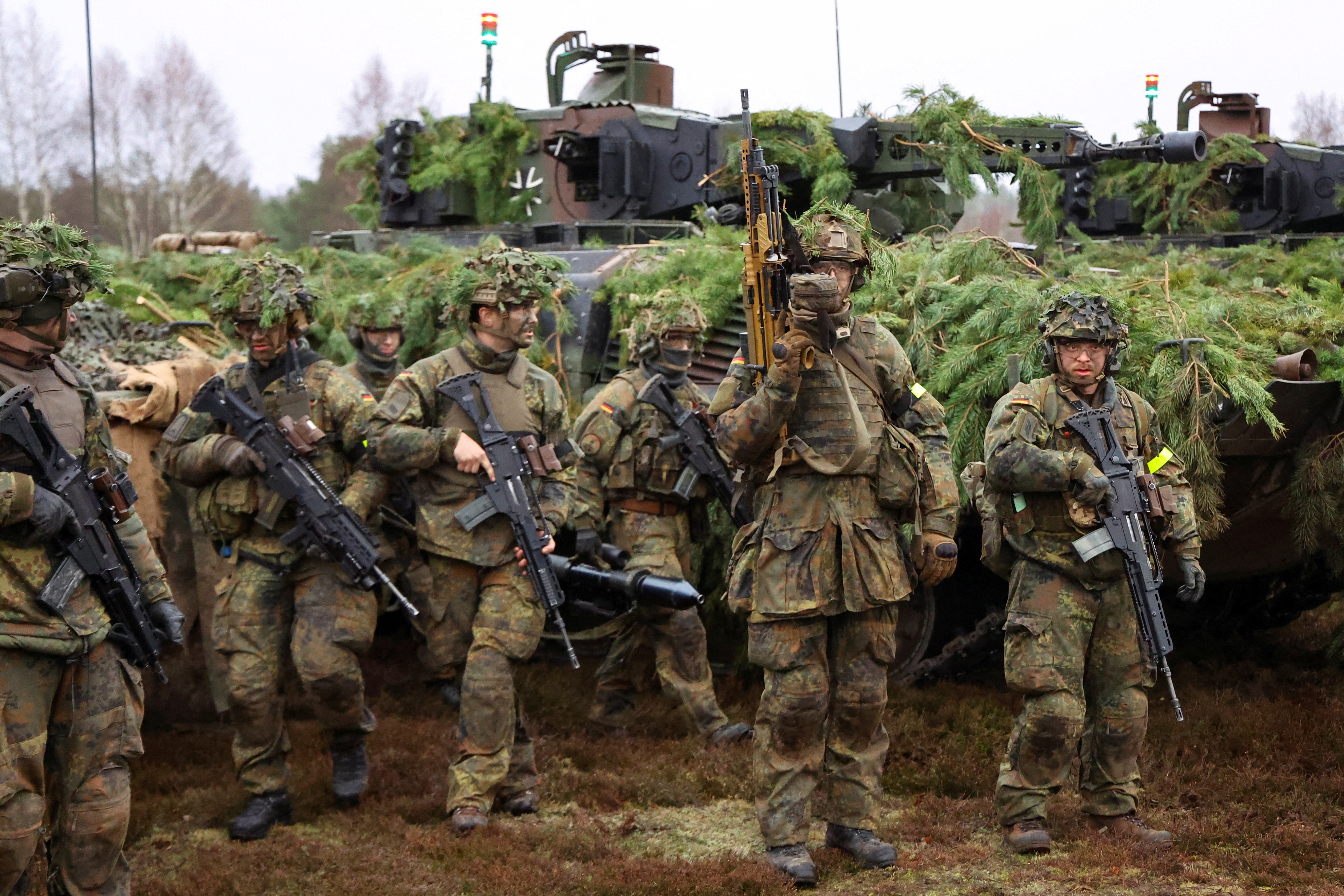 Soldiers of German armed forces Bundeswehr stand by Puma infantry fighting vehicles during firing practice, at armoured infantry training area in Altengrabow, Germany