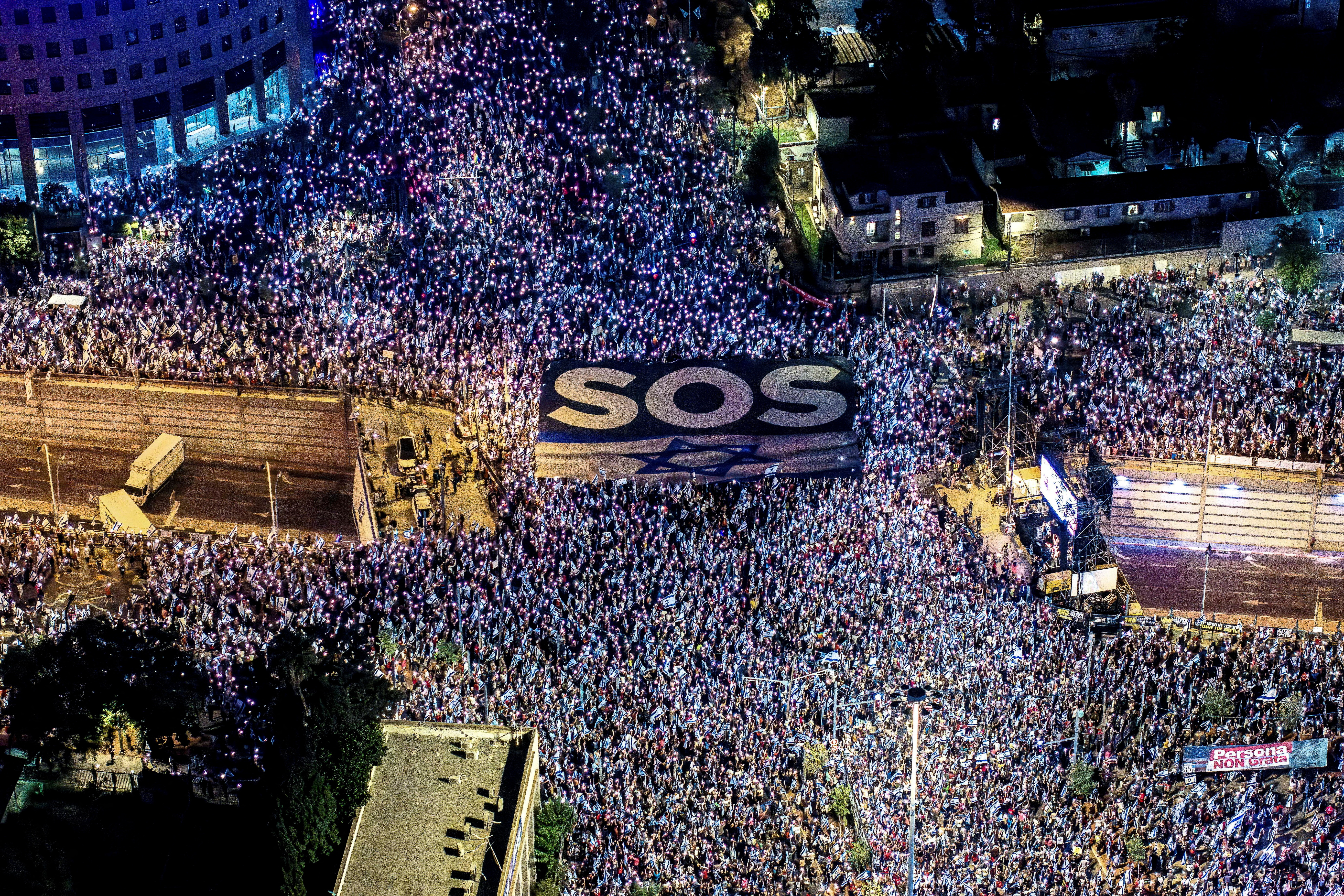 Israelis take part in a demonstration against Israeli Prime Minister Benjamin Netanyahu and his nationalist coalition government's judicial overhaul, in Tel Aviv