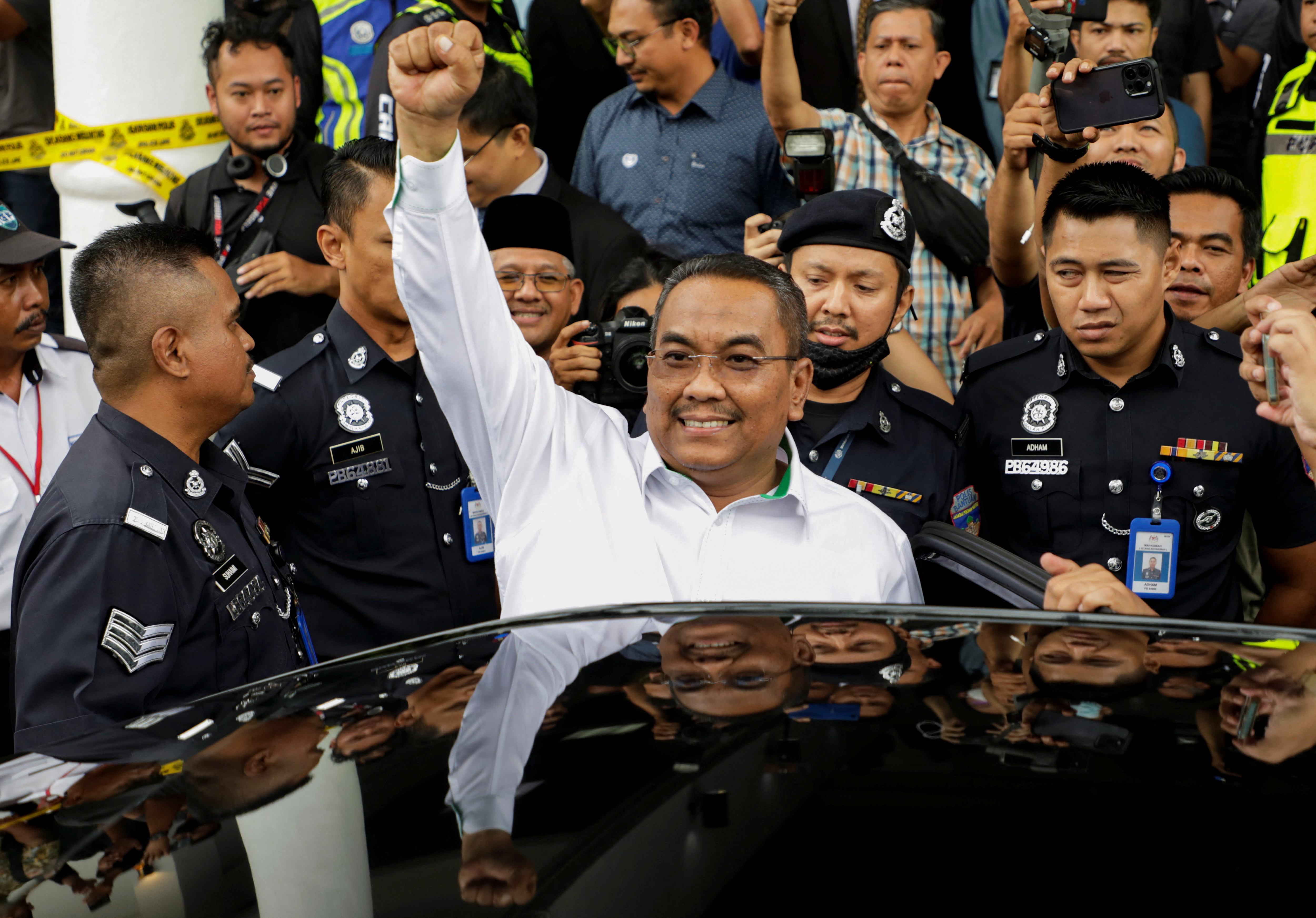 Malaysia opposition leader Muhammad Sanusi Md Nor raises his fist as he leaves a court where he was charged in Gombak, Malaysia July 18, 2023. REUTERS/Hasnoor Hussain