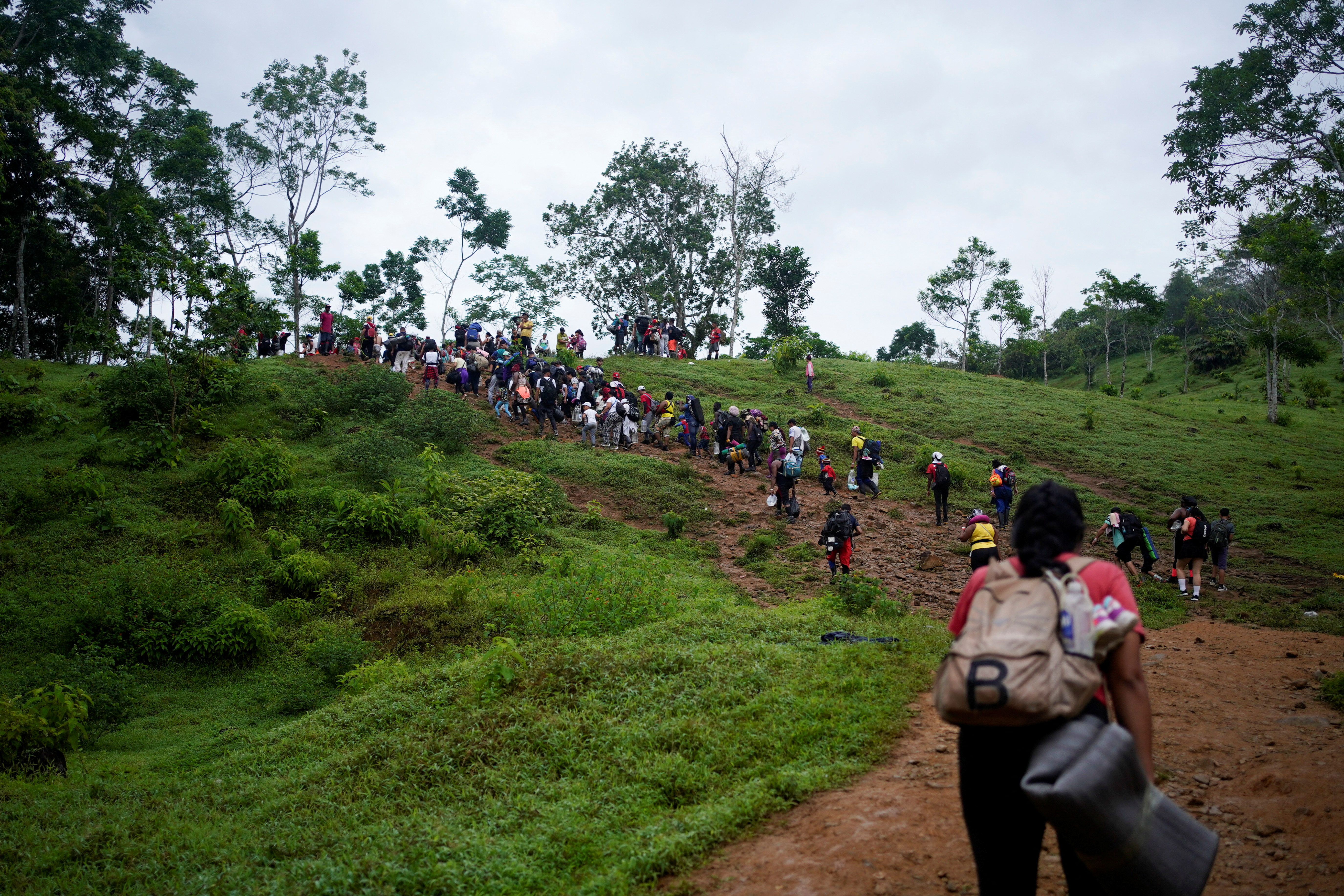 A group of migrants from different countries walk through the Darien Gap