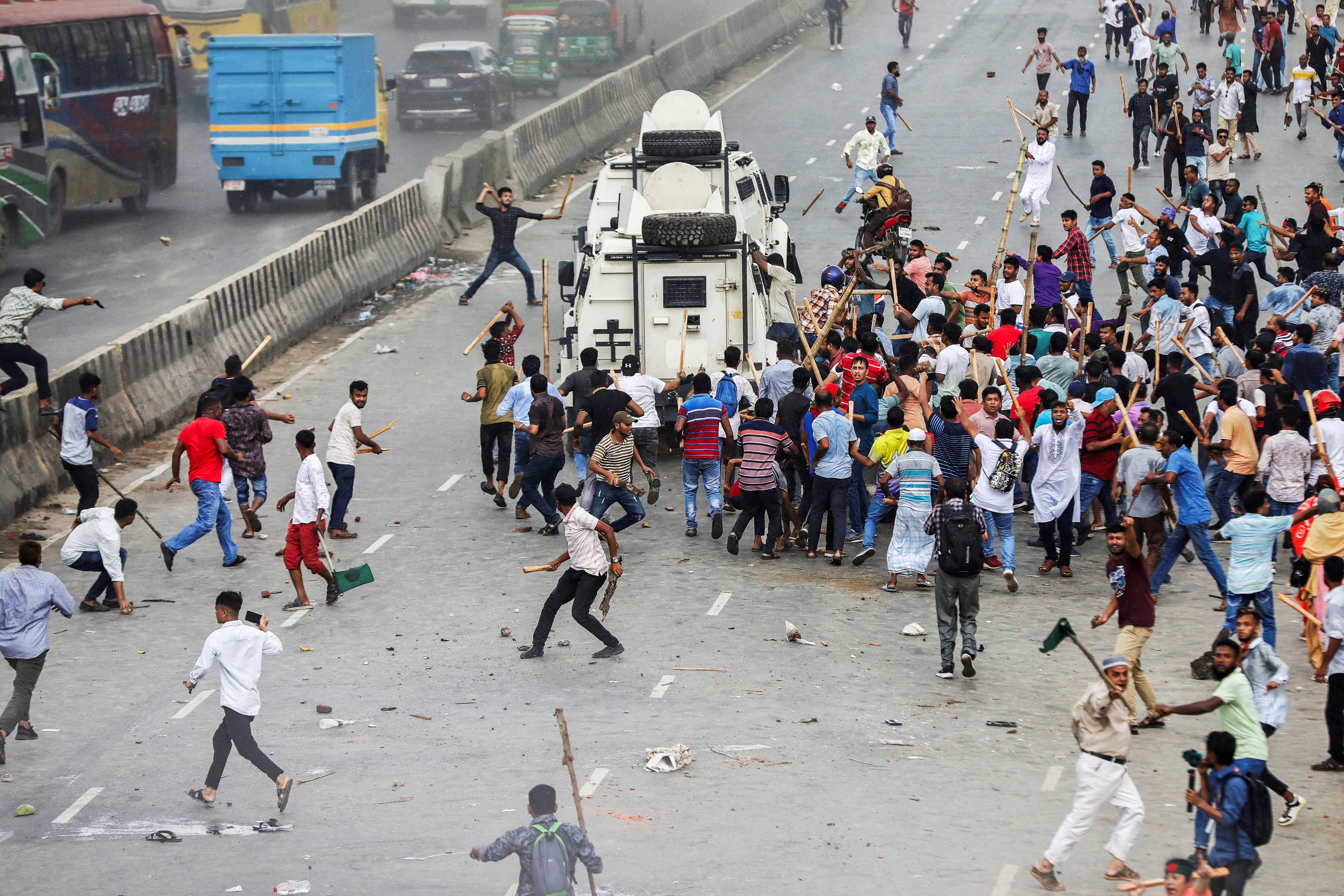 Supporters of the Bangladesh Nationalist Party (BNP) attack armed vehicles of police at Shonir Akhra area