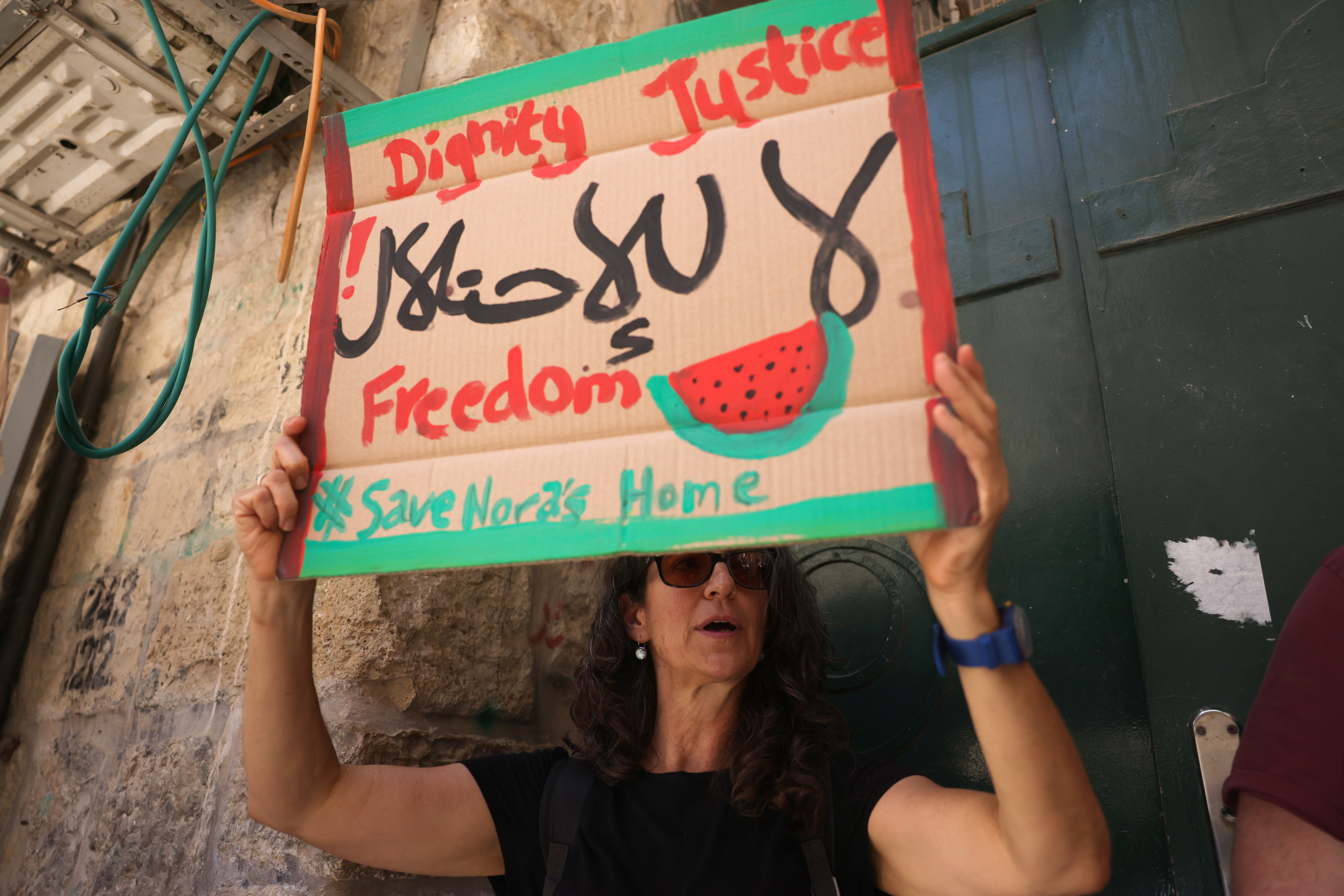 A woman lifts a placard
