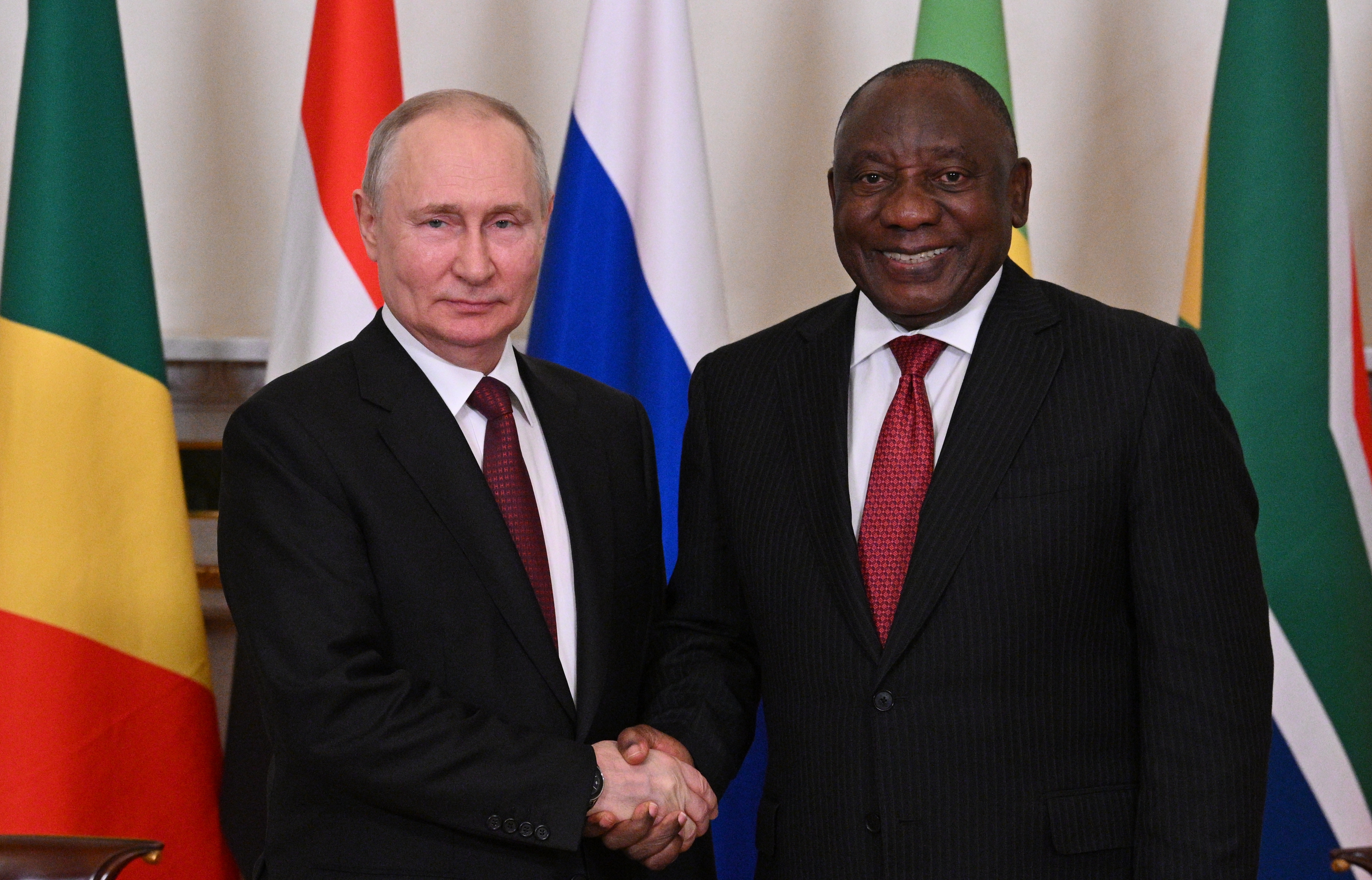Russian President Vladimir Putin shaking hands with South Africa's President Cyril Ramaphosa