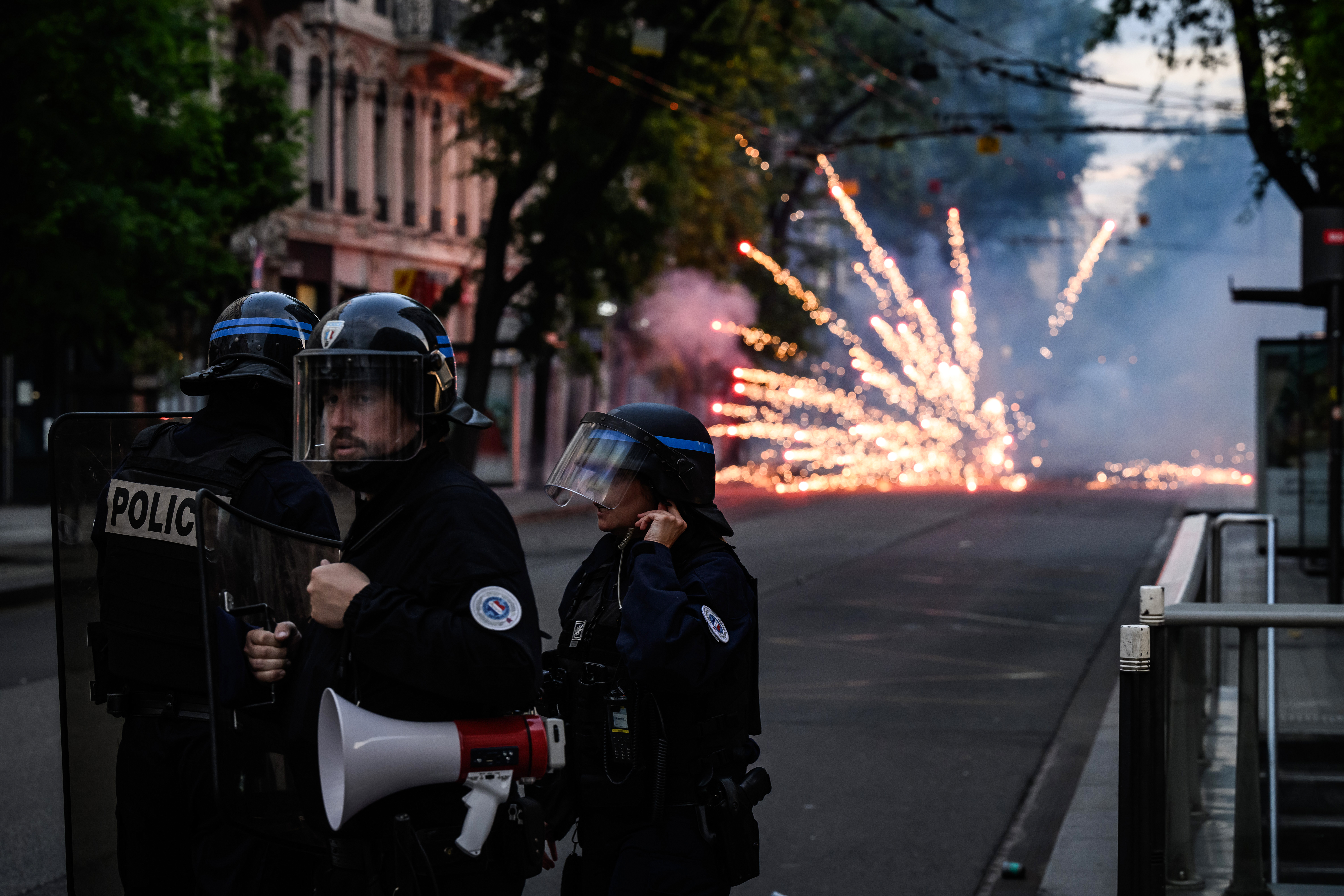 French riot police stand guard during clashes in Lyon, south-eastern France, on June 30, 2023, three days after a 17-year-old boy was shot in the chest by police at point-blank range in Nanterre, a western suburb of Paris. - French President Emmanuel Macron has announced measures including more police and urged parents to keep minors off the streets as he battled to contain nightly riots over a teenager's fatal shooting by an officer in a traffic stop. (Photo by JEFF PACHOUD / AFP)