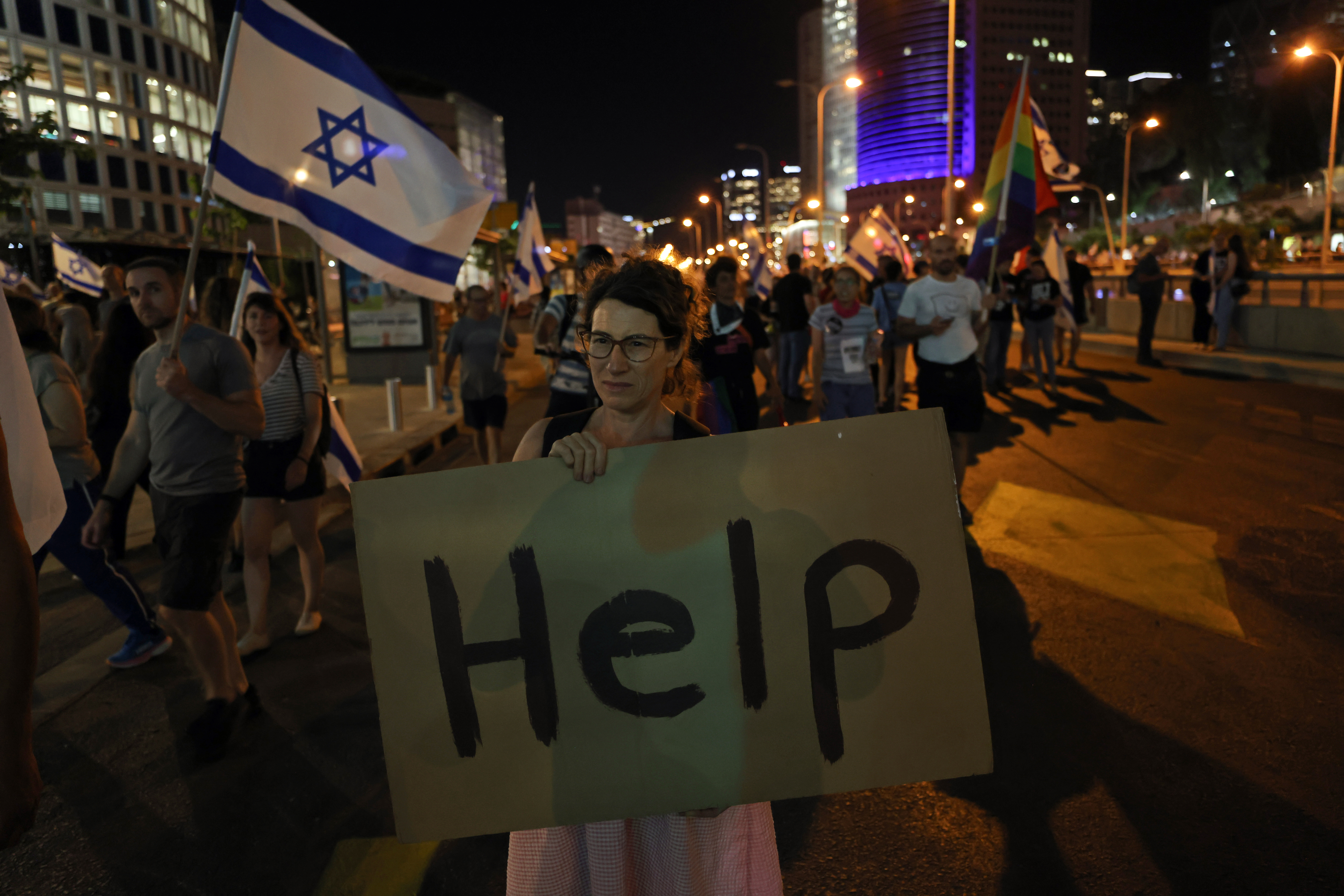 A demonstrator holds a placard