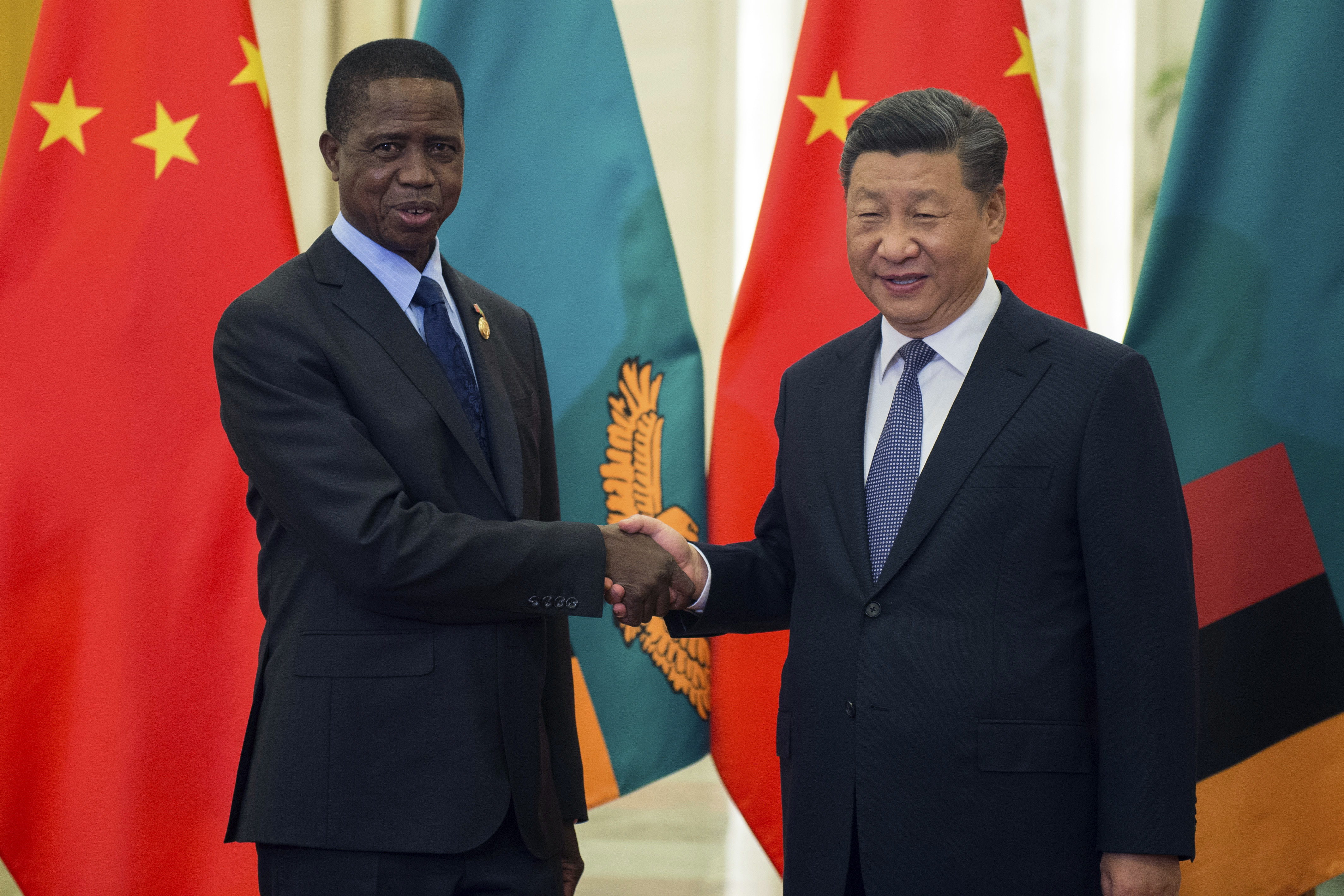 Zambia's President Edgar Lungu, left, shake hands with China's President Xi Jinping, prior to their bilateral meeting at the Great Hall of the People, in Beijing, China, Saturday, Sept. 1, 2018 ahead of the Forum on China-Africa Cooperation which will be held Sept. 3-4. (Nicolas Asfouri/Pool Photo via AP)