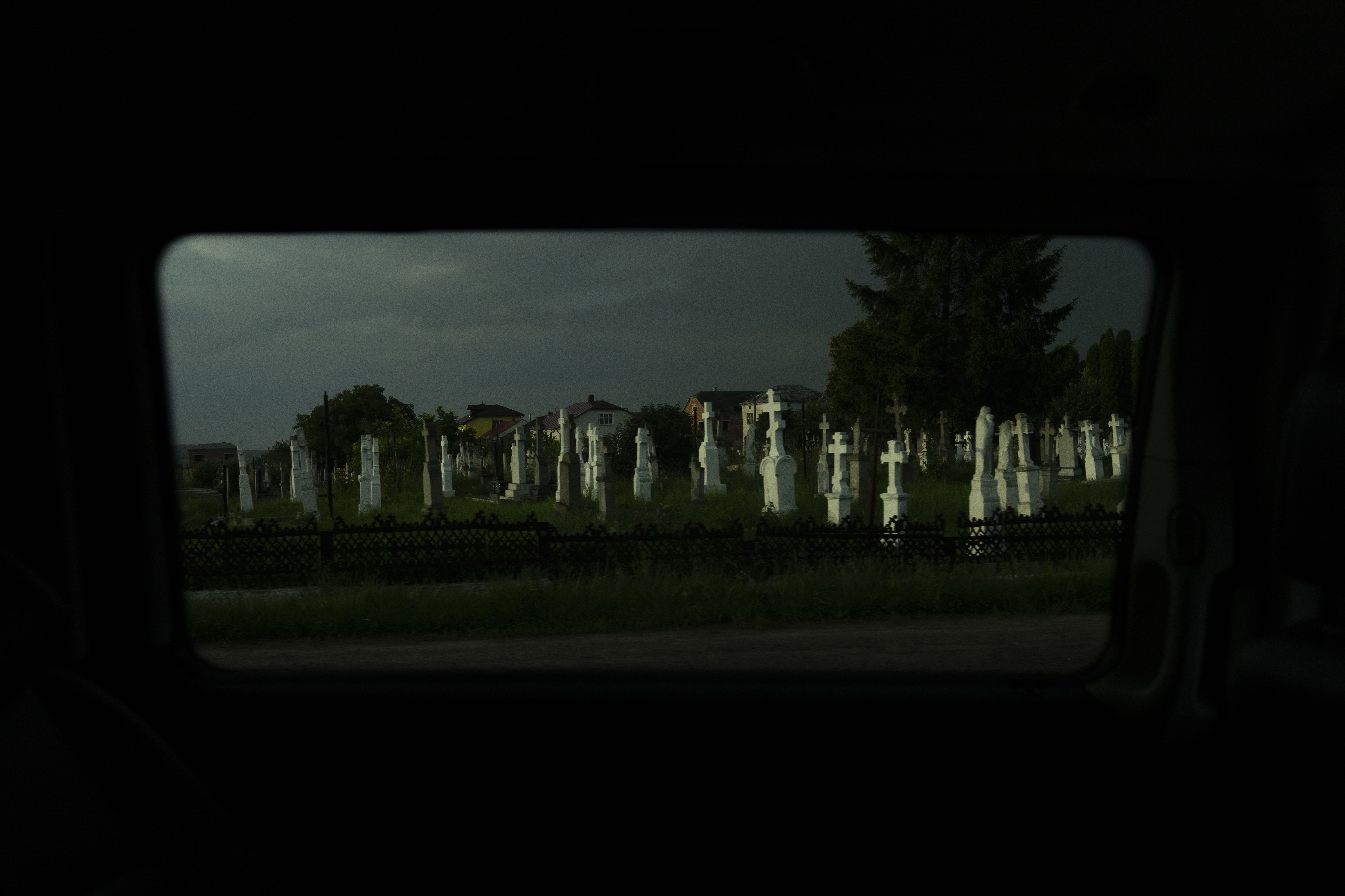 A cemetery is lit by the evening sunlight near Lviv, Ukraine, Sunday,
