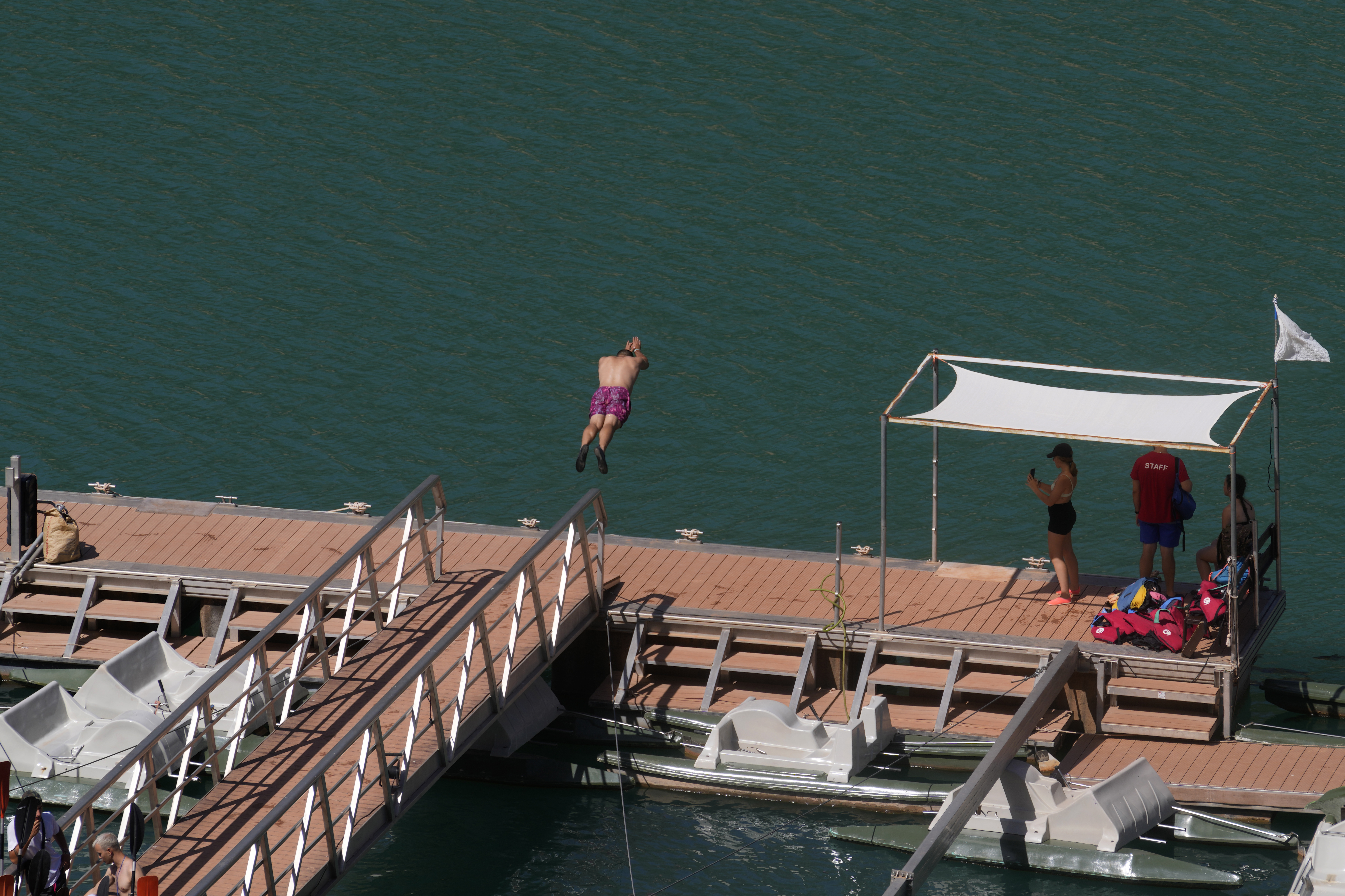 A man dives into the water from a platform at the Tranco reservoir near Beas de Segura, Jaen, in southern Spain,