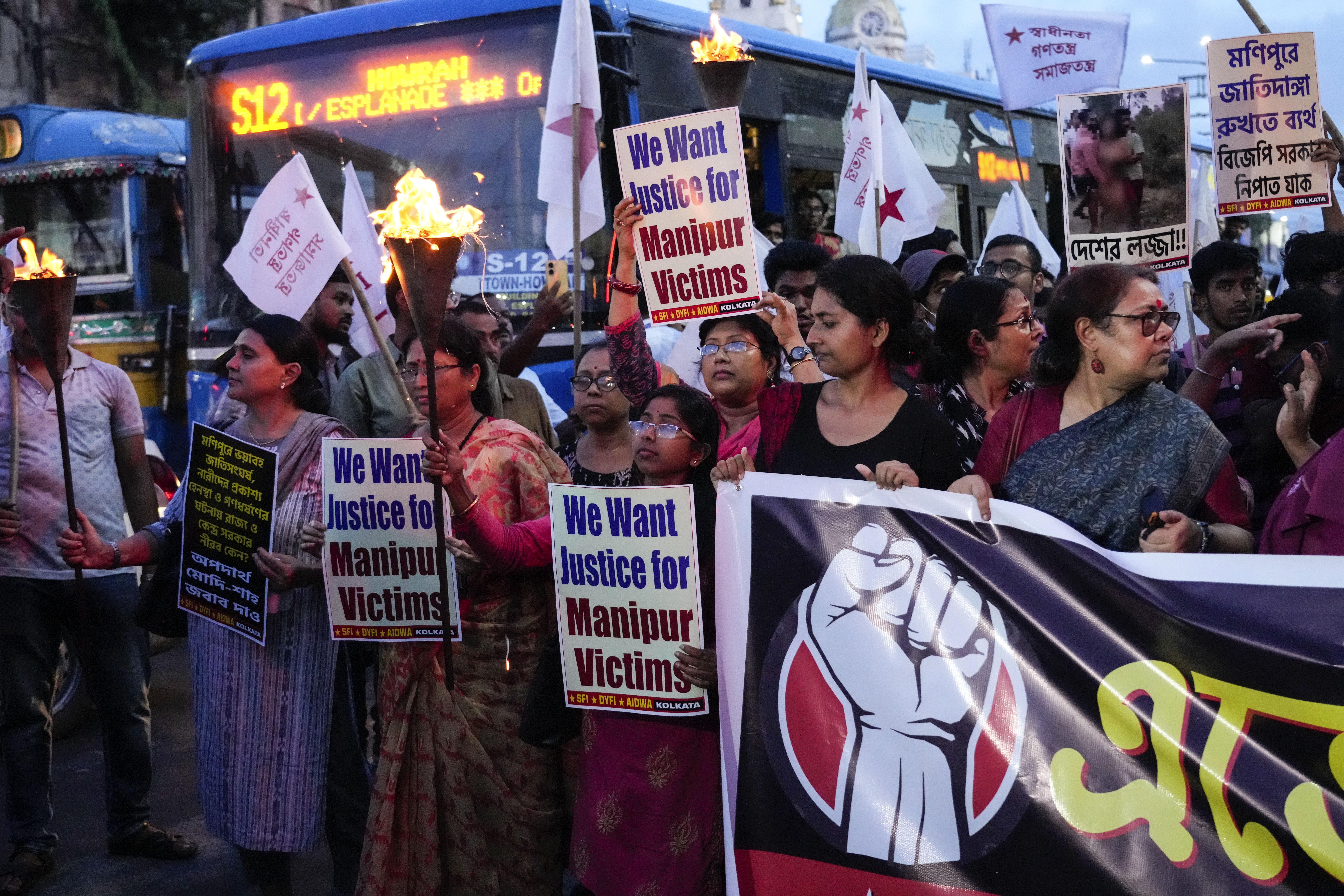 People participate in a protest against ethnic violence in Kolkata