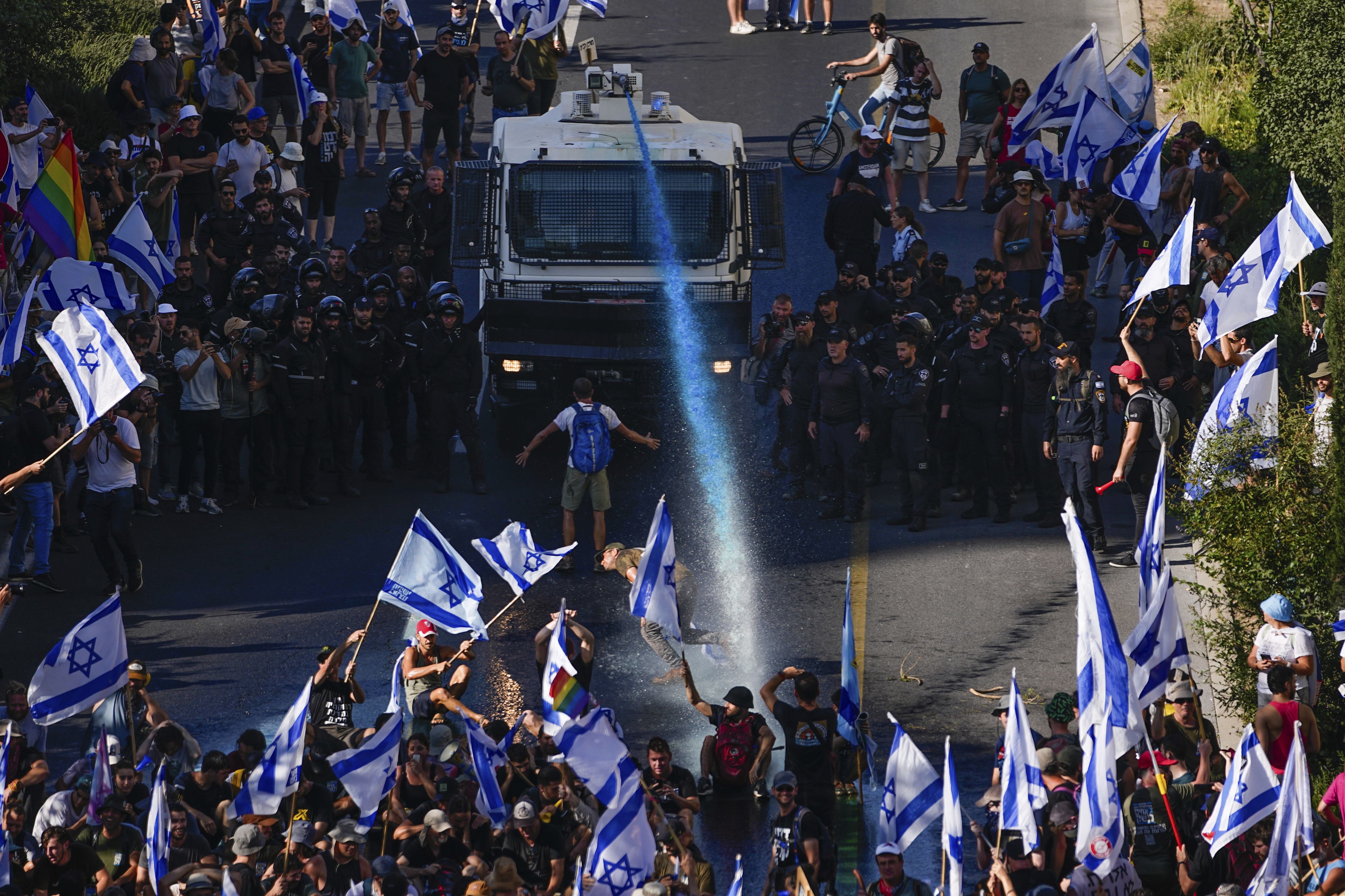 Israeli police use a water cannon to disperse demonstrators