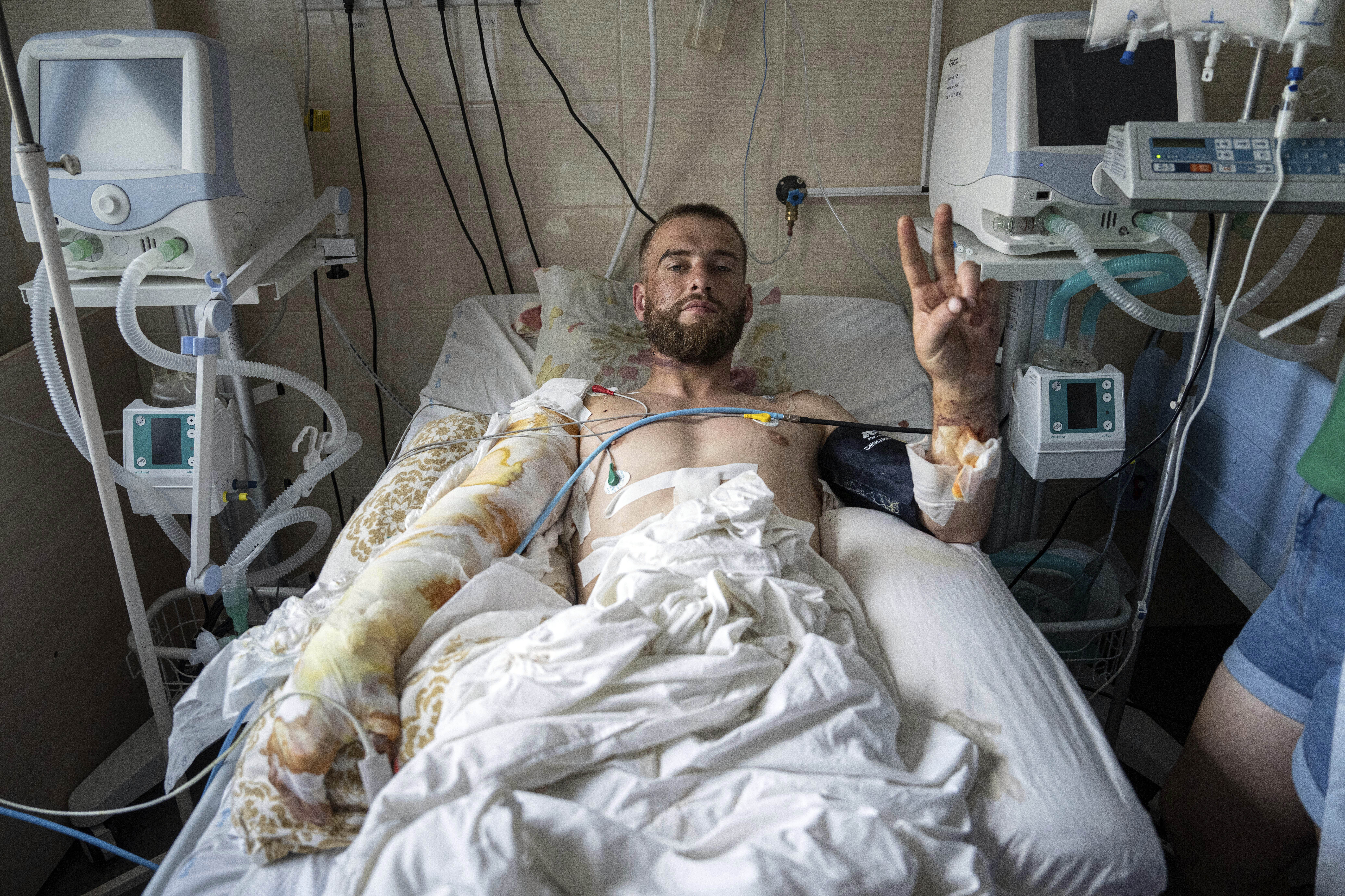 Kaiman, a Ukrainian serviceman, shows a Victory sign