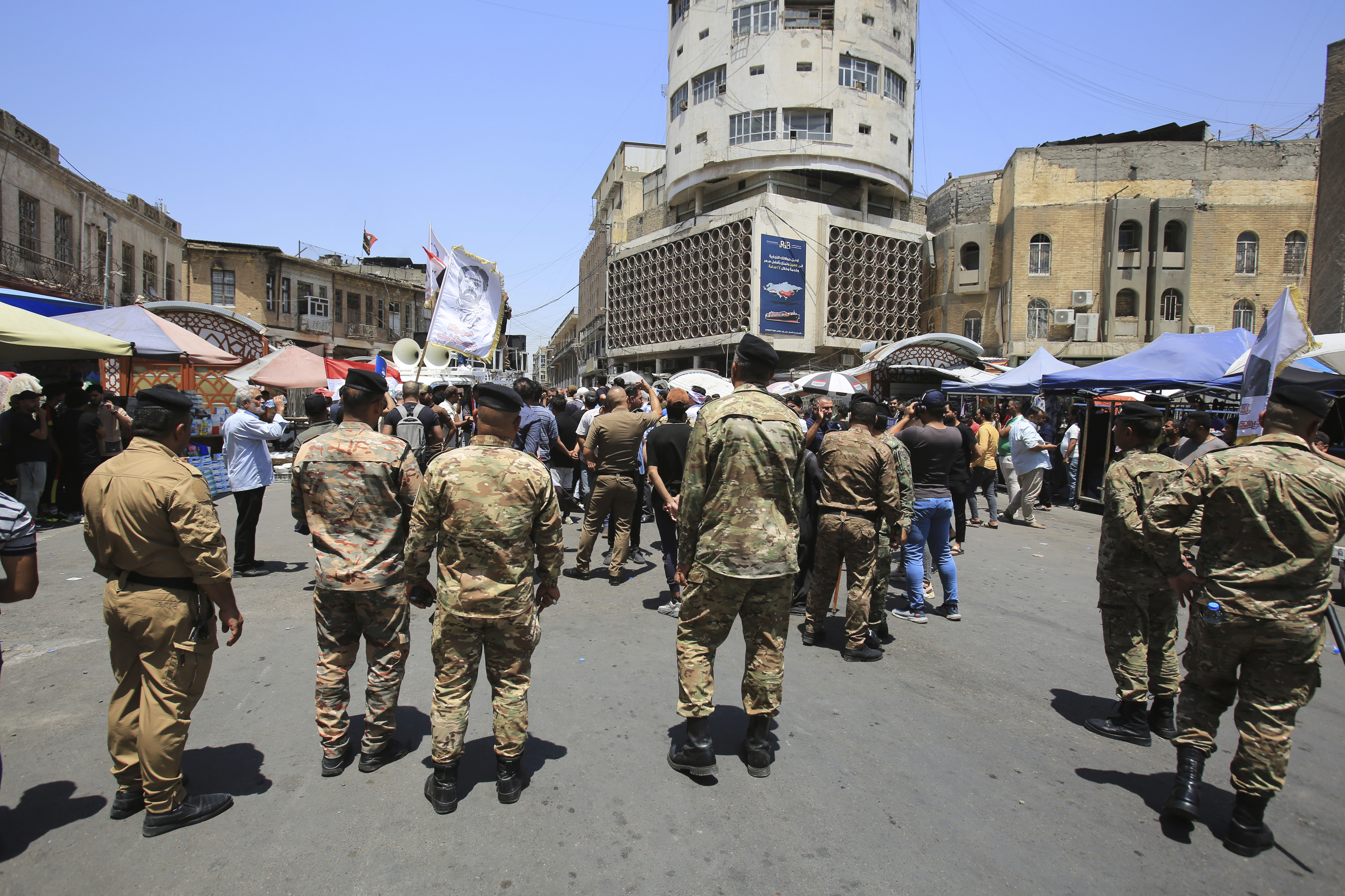 Security forces stand guard during a demonstration in front of the Iraqi central bank as currency plummets against the U.S. dollar, in Baghdad, Iraq