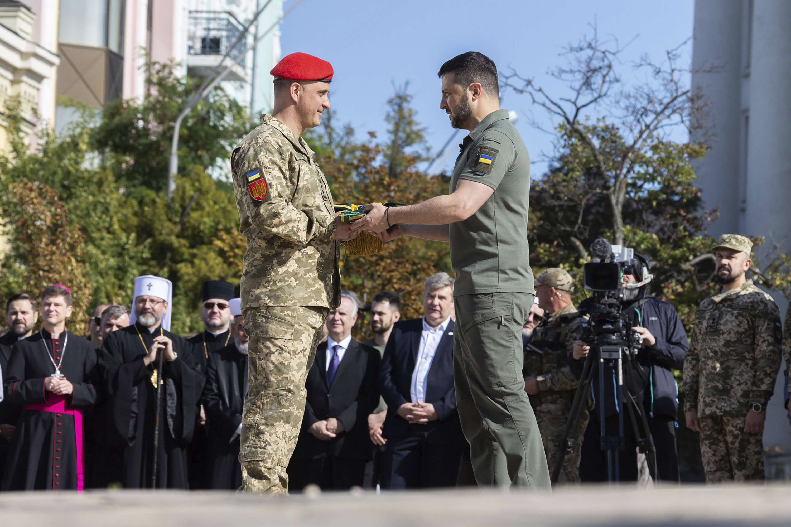 Zelenskyy, centre right, awards a serviceman during an event for marking Statehood Day in Mykhailivska Square in Kyiv