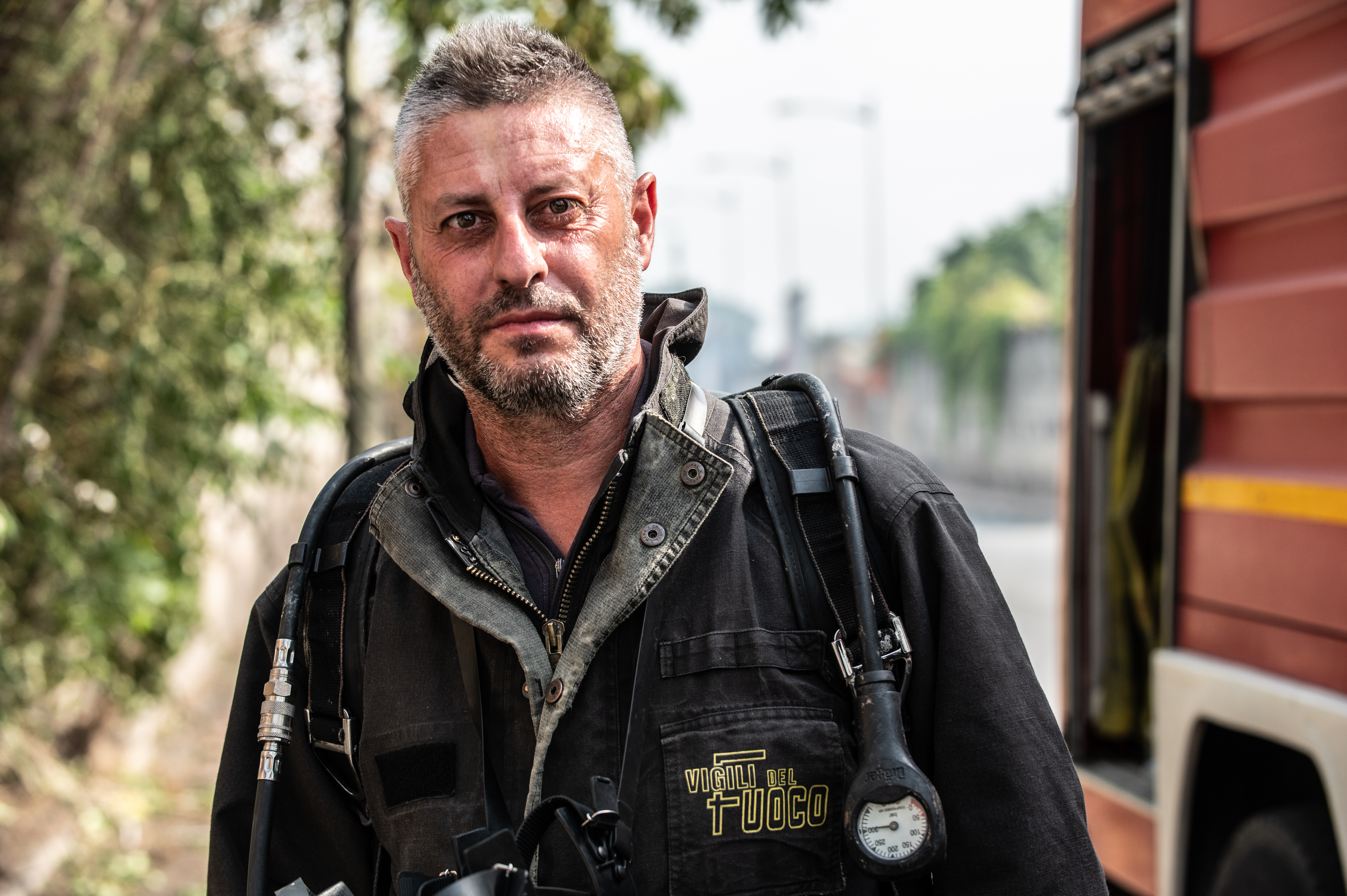 A firefighter looks exhausted after putting out numerous fires