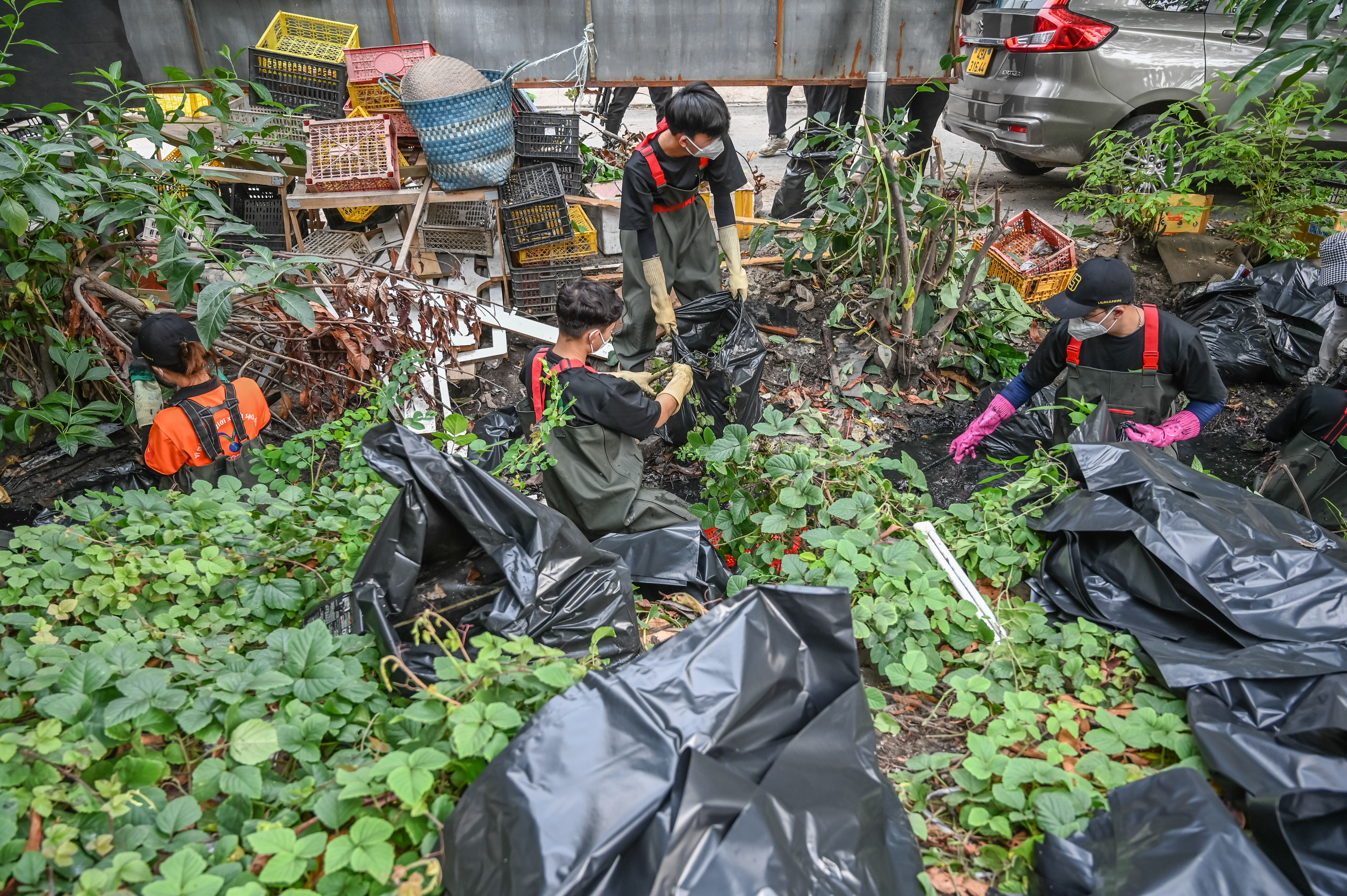 Volunteers cleaning up a fetid canal 