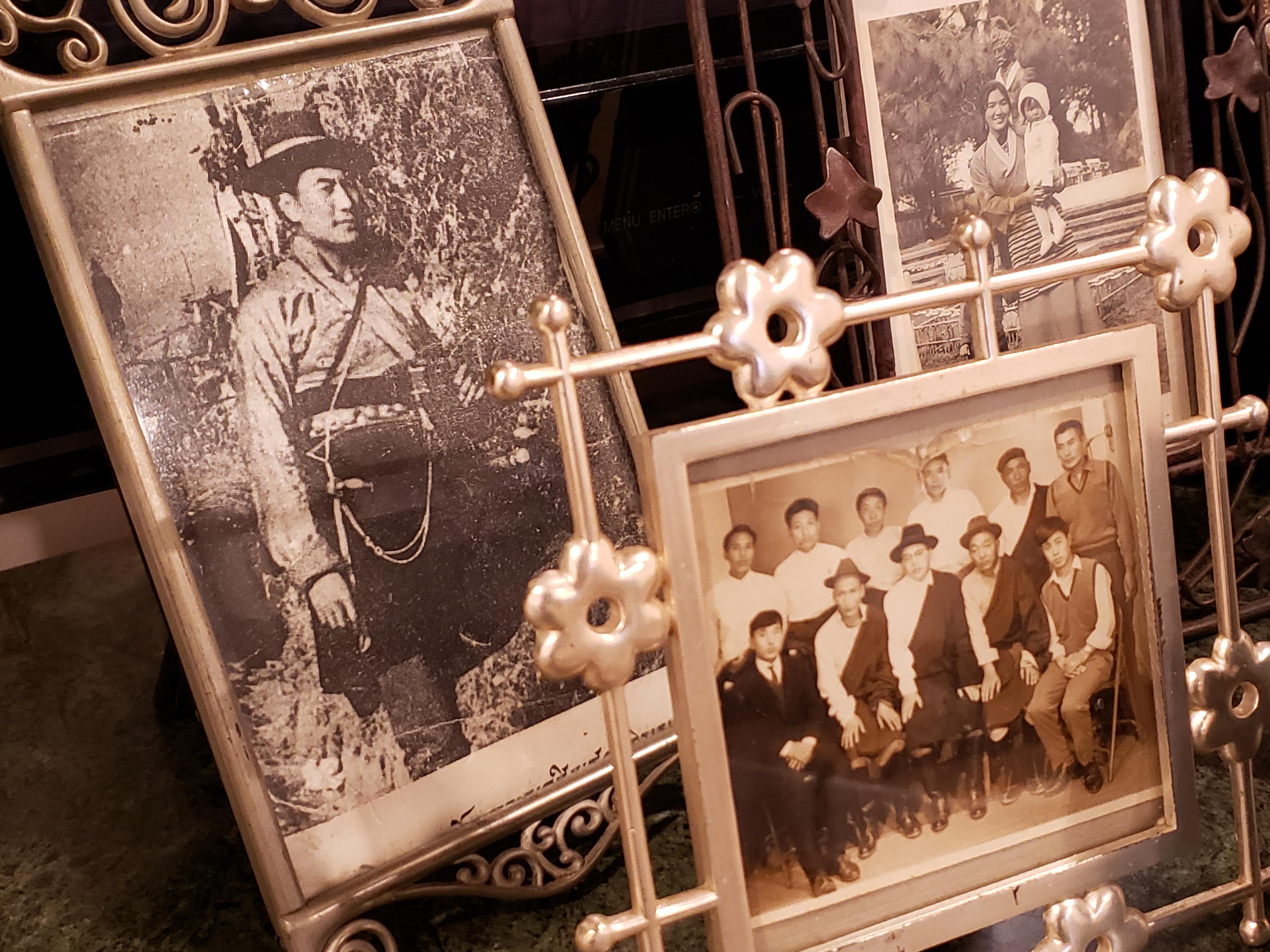A selection of photos on display in Tsultrim's home, One on the left shows him as a young man when he was a resistance fighter.