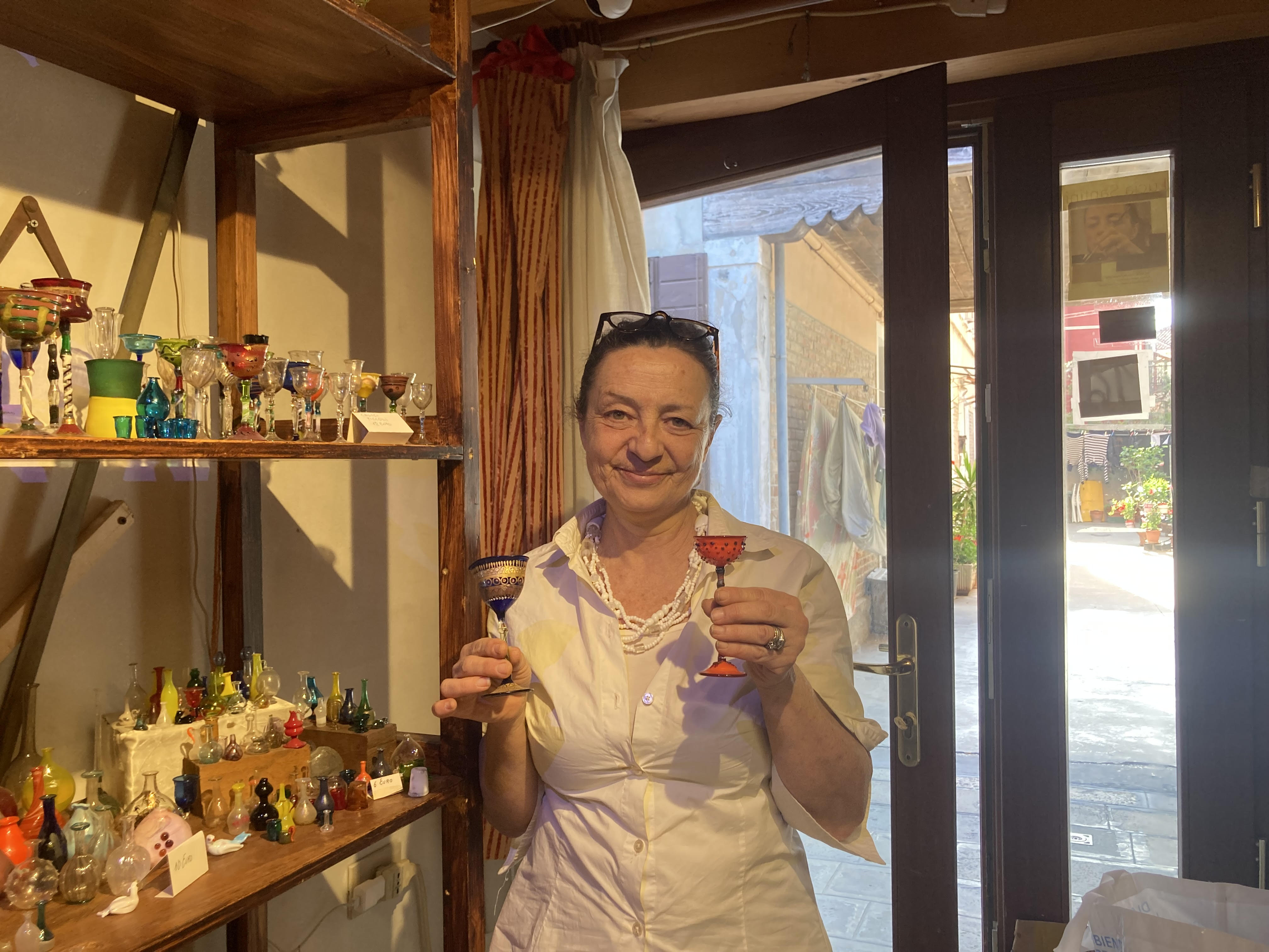 A woman holds up glass chalices
