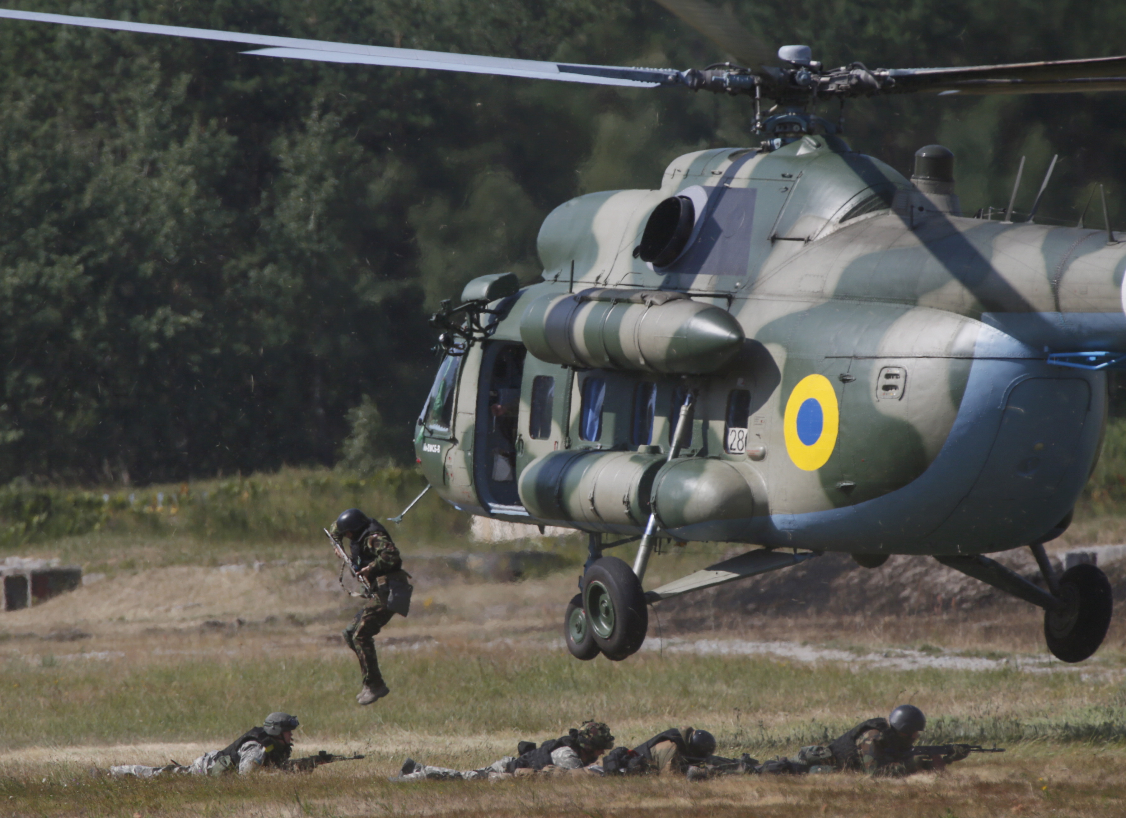 Members of the National Guard of Ukraine jump out a MI-8 helicopter during military tactical exercises at a training base near Kiev, Ukraine, July 22, 2015. REUTERS/Valentyn Ogirenko