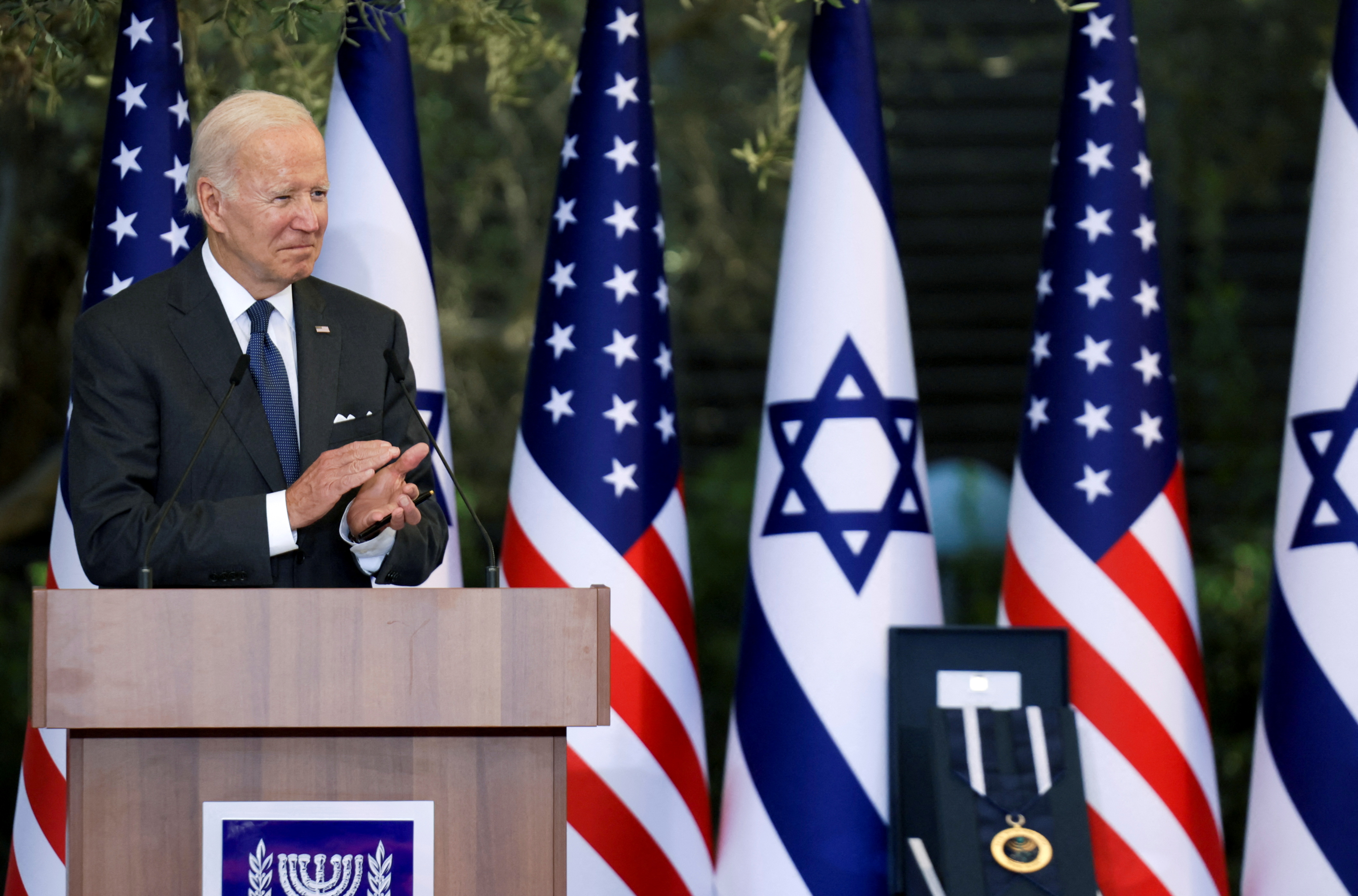US President Joe Biden speaks at a podium in Jerusalem in front of US and Israeli flags