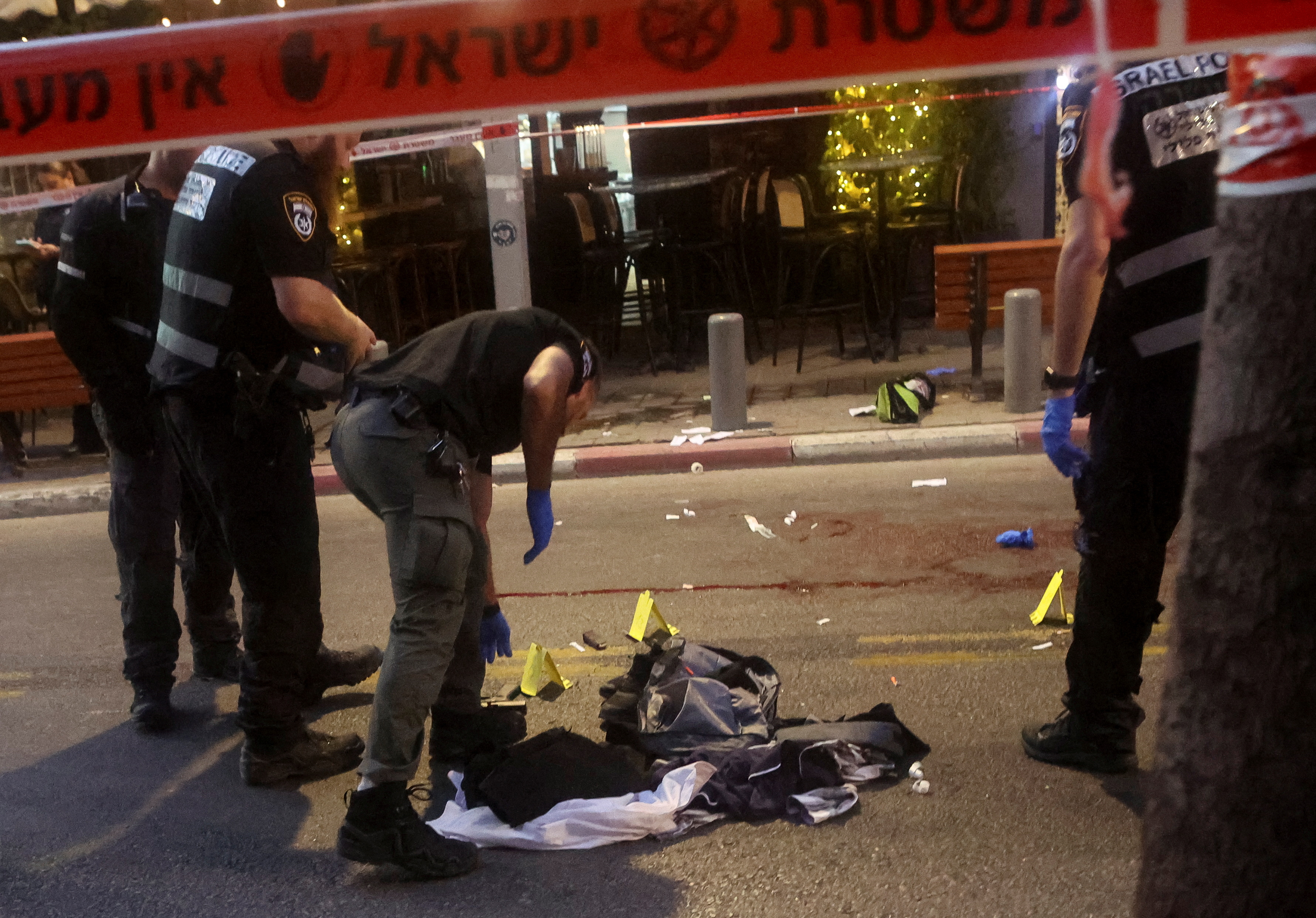 Israeli police inspect the scene of a suspected shooting attack in Tel Aviv, Israel