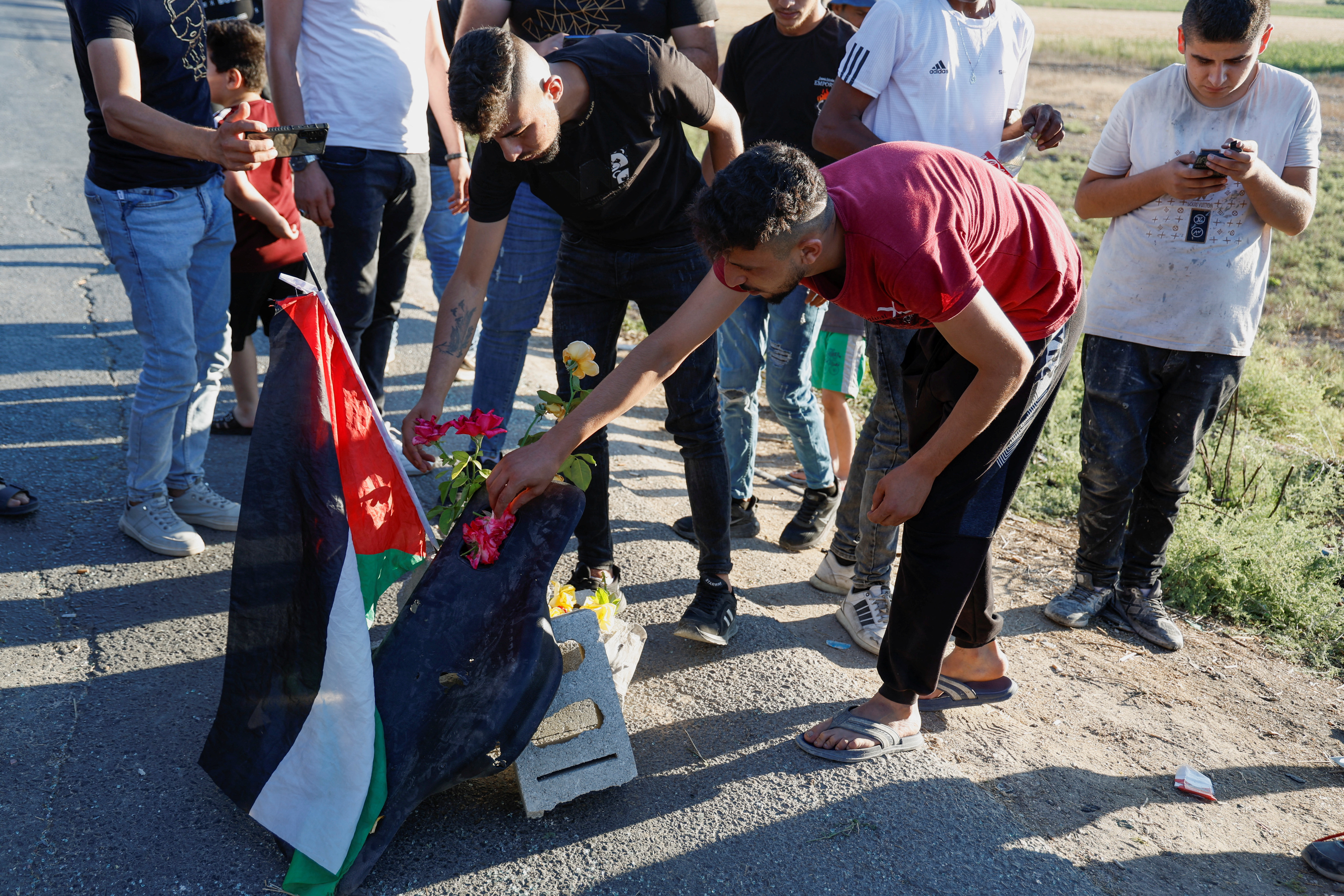 Palestinians gather at the scene where Israeli forces targeted a Palestinian car, near Jenin,