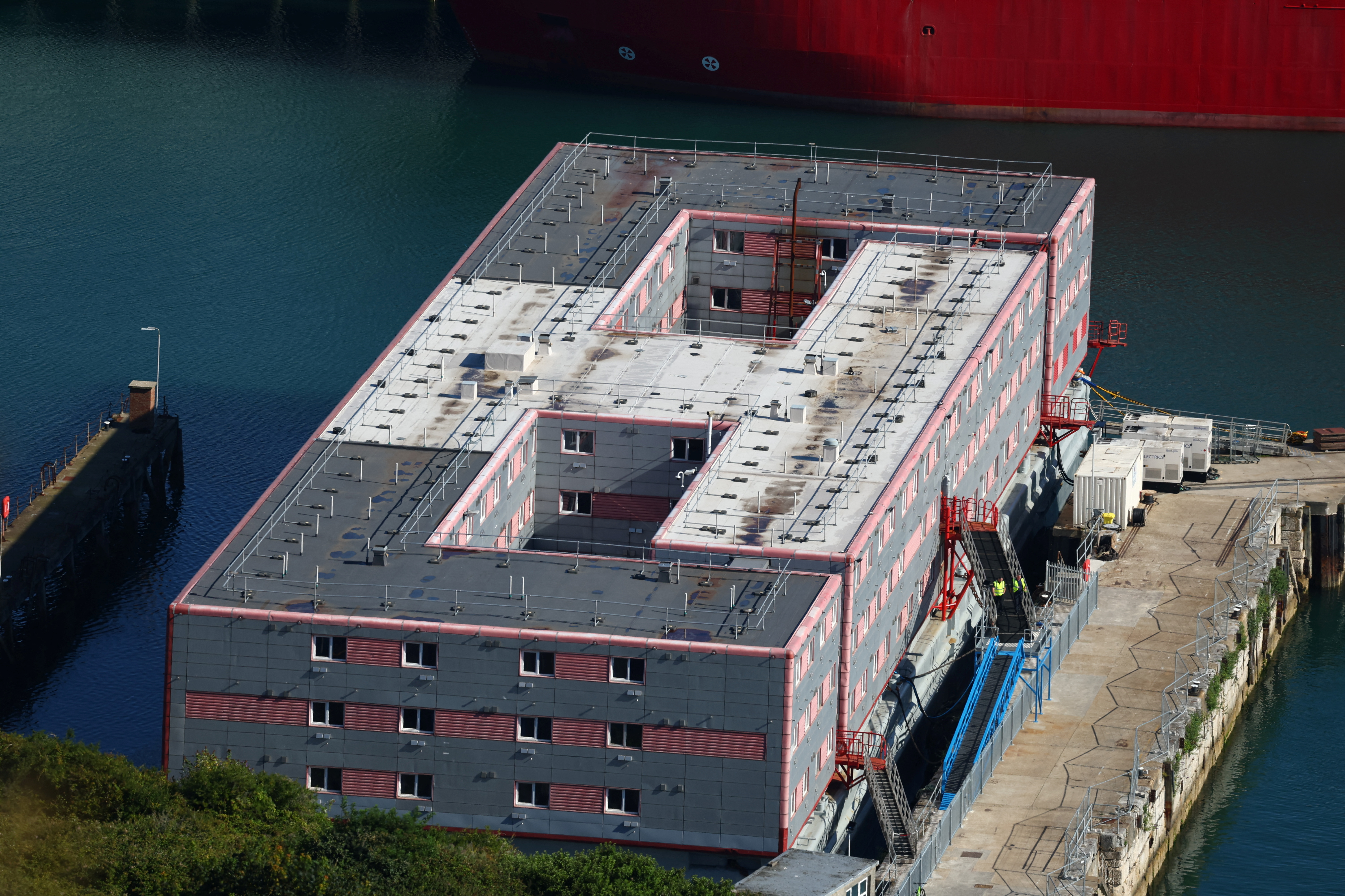 Some officials are aboard the Bibby Stockholm barge at Portland, near Poole, Britain