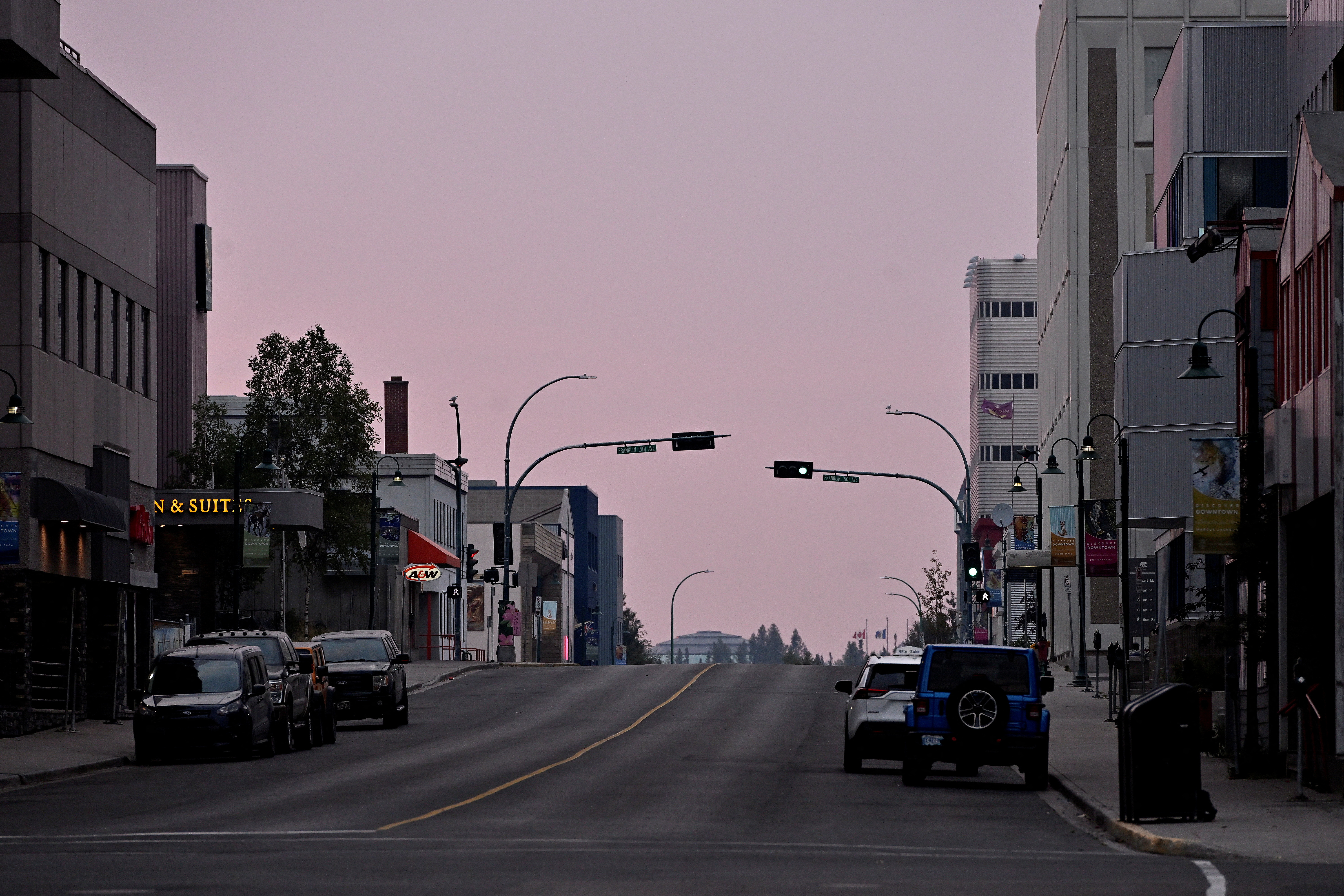 A pink sky is seen as wildfires threaten Yellowknife, Canada