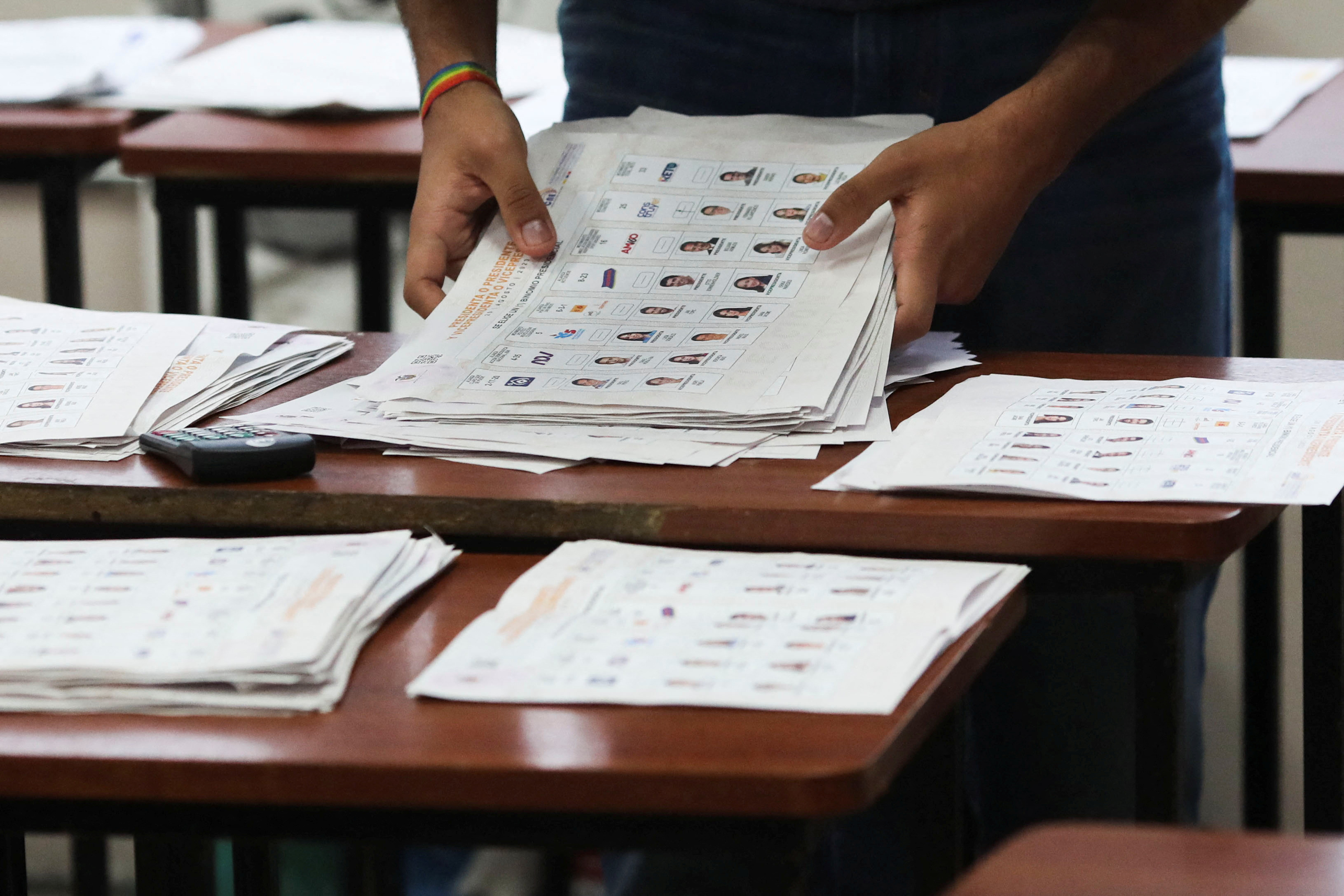 An electoral worker takes part in the ballot count process at a polling station during the presidential election, in Quito, Ecuador.