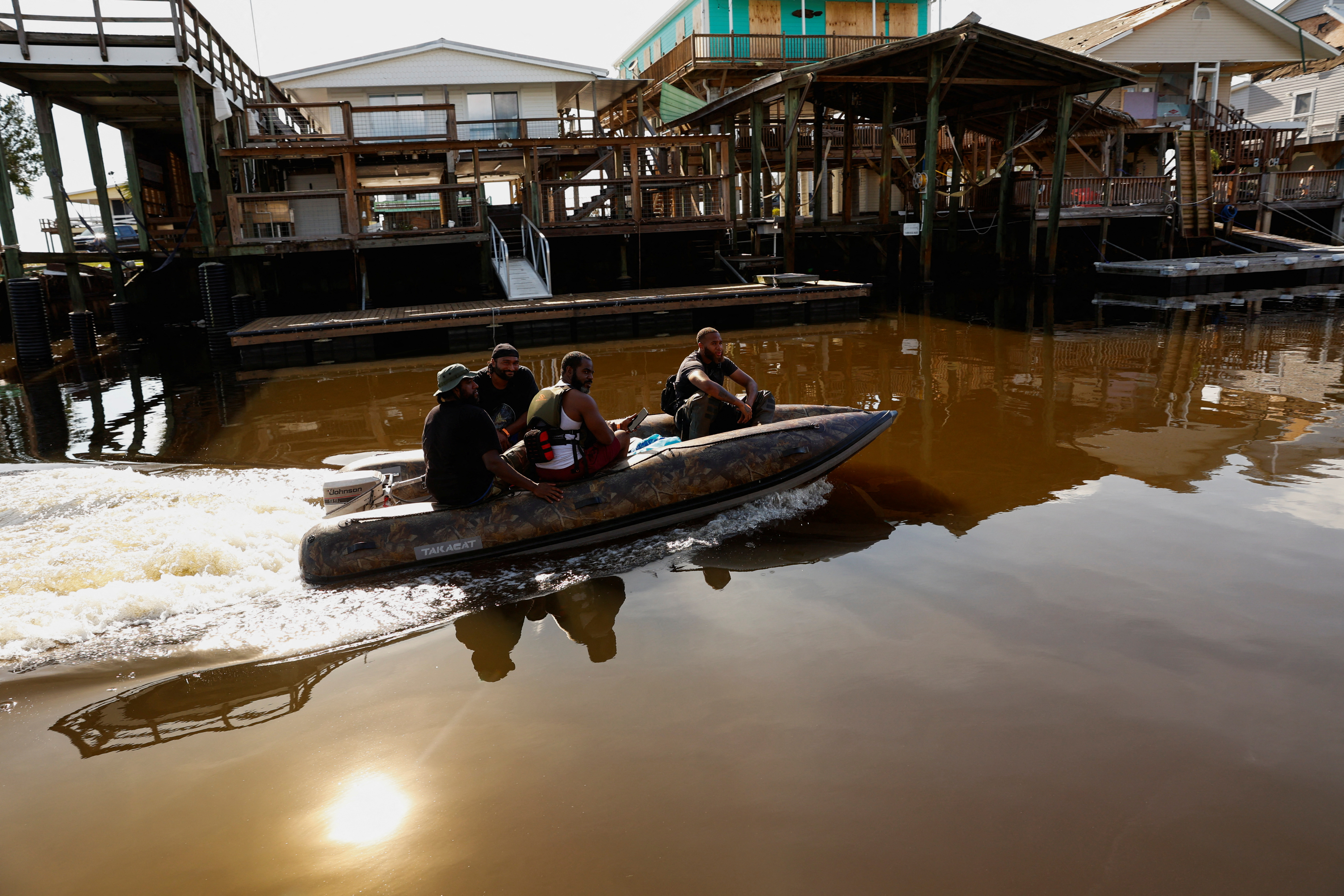 A small motorboat traverses flood waters in Keaton Beach.