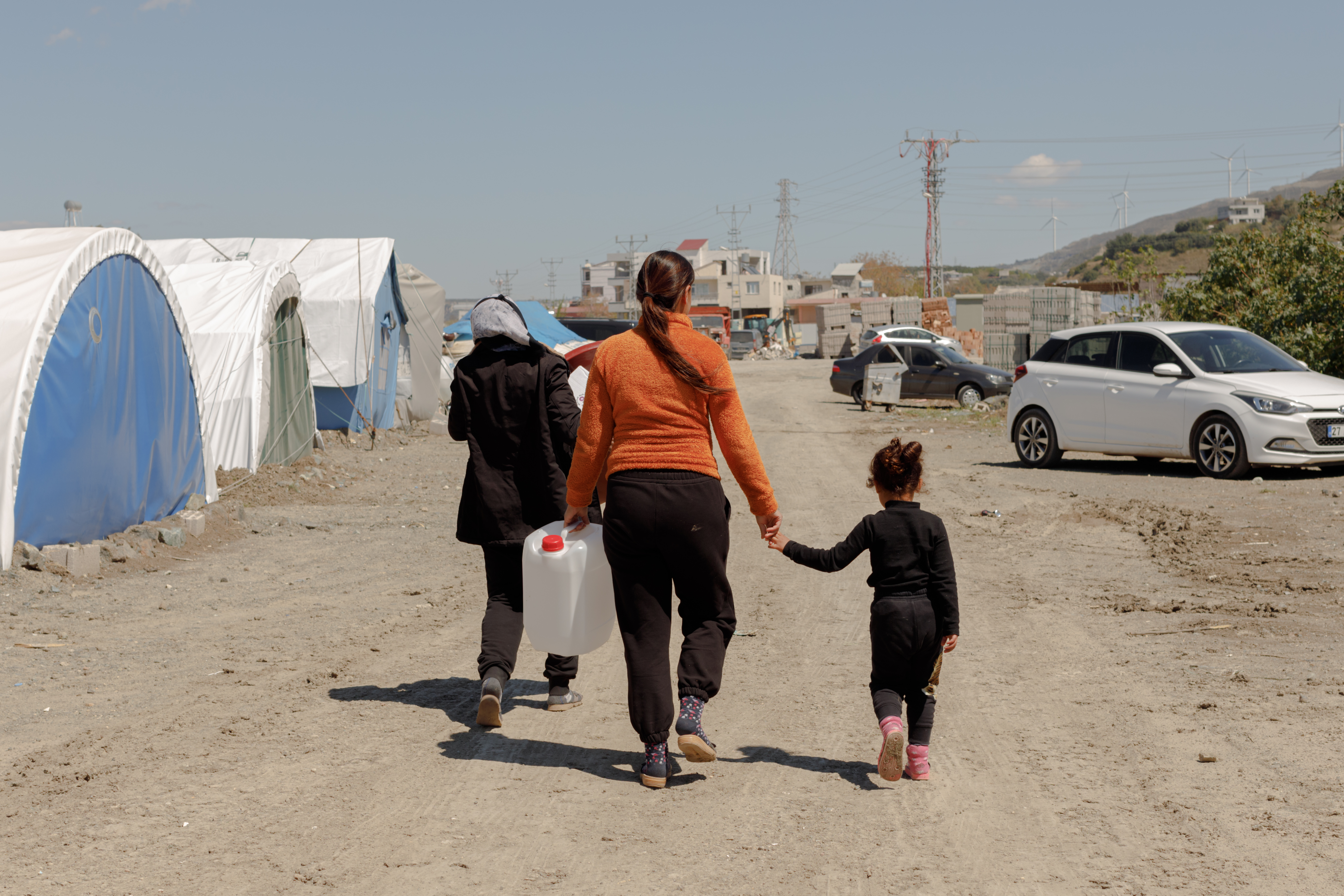 A mother and daughter return from a distribution of hygiene kits