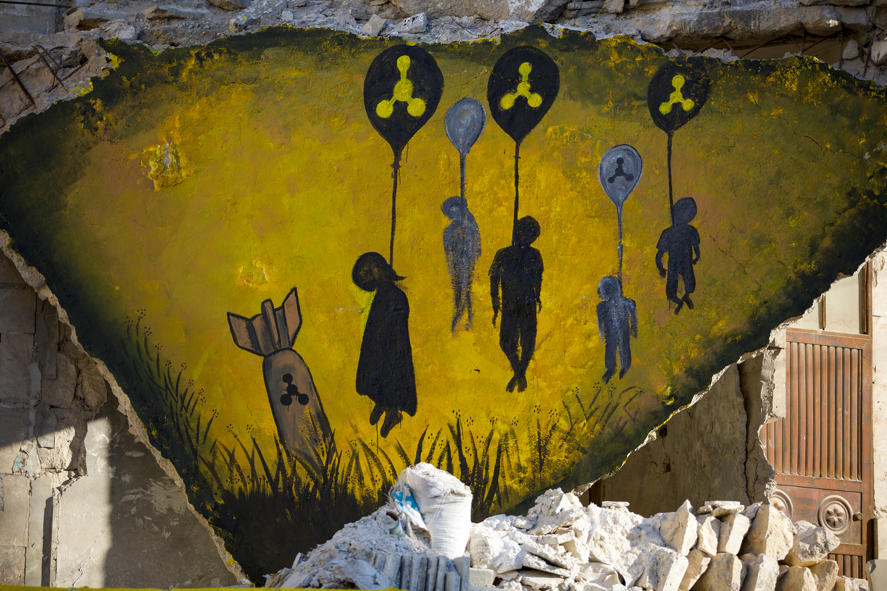 A mural showing the shadows of lifeless bodies hung by a chemical balloon