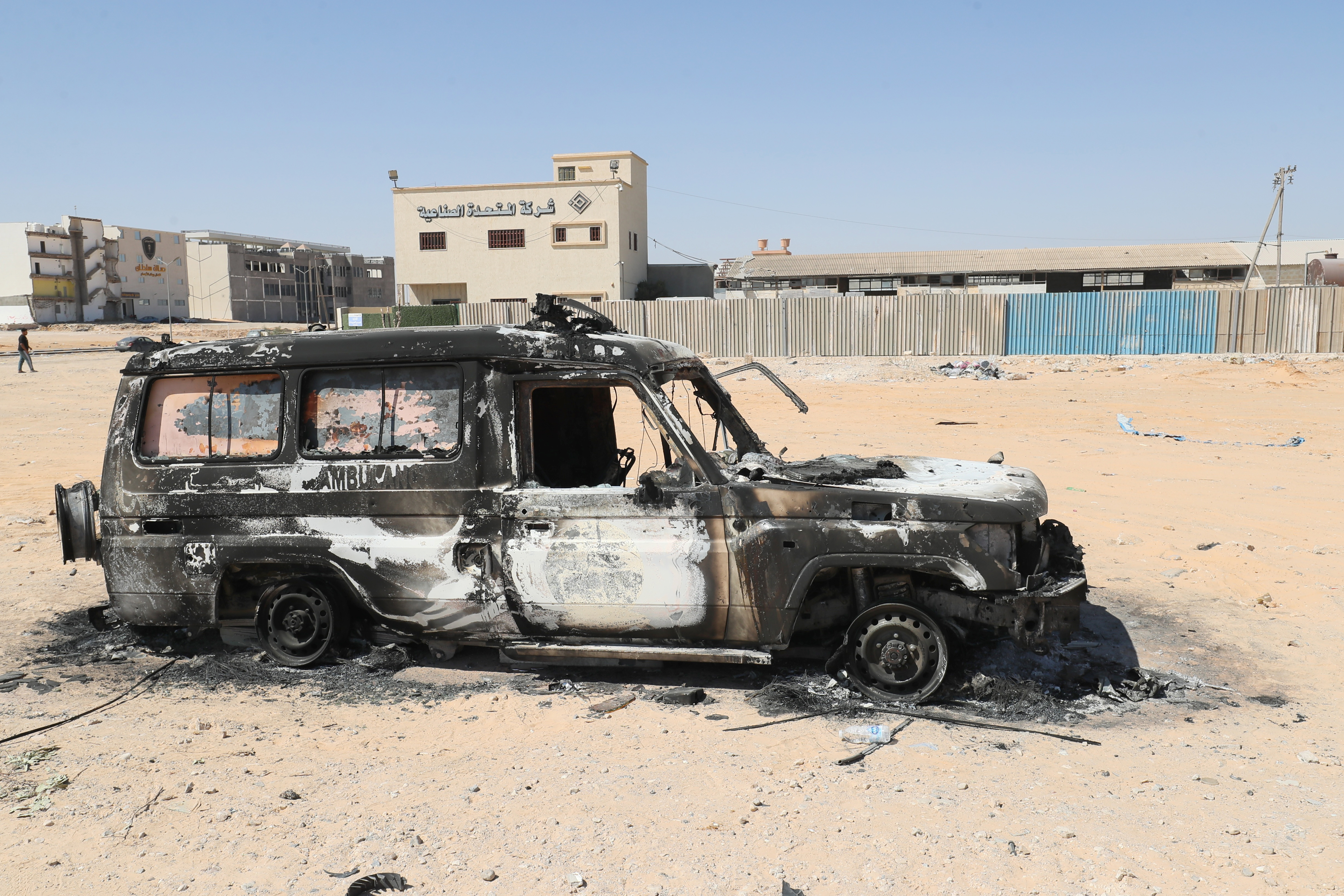 The carcass of a burnt car is pictured in Libya