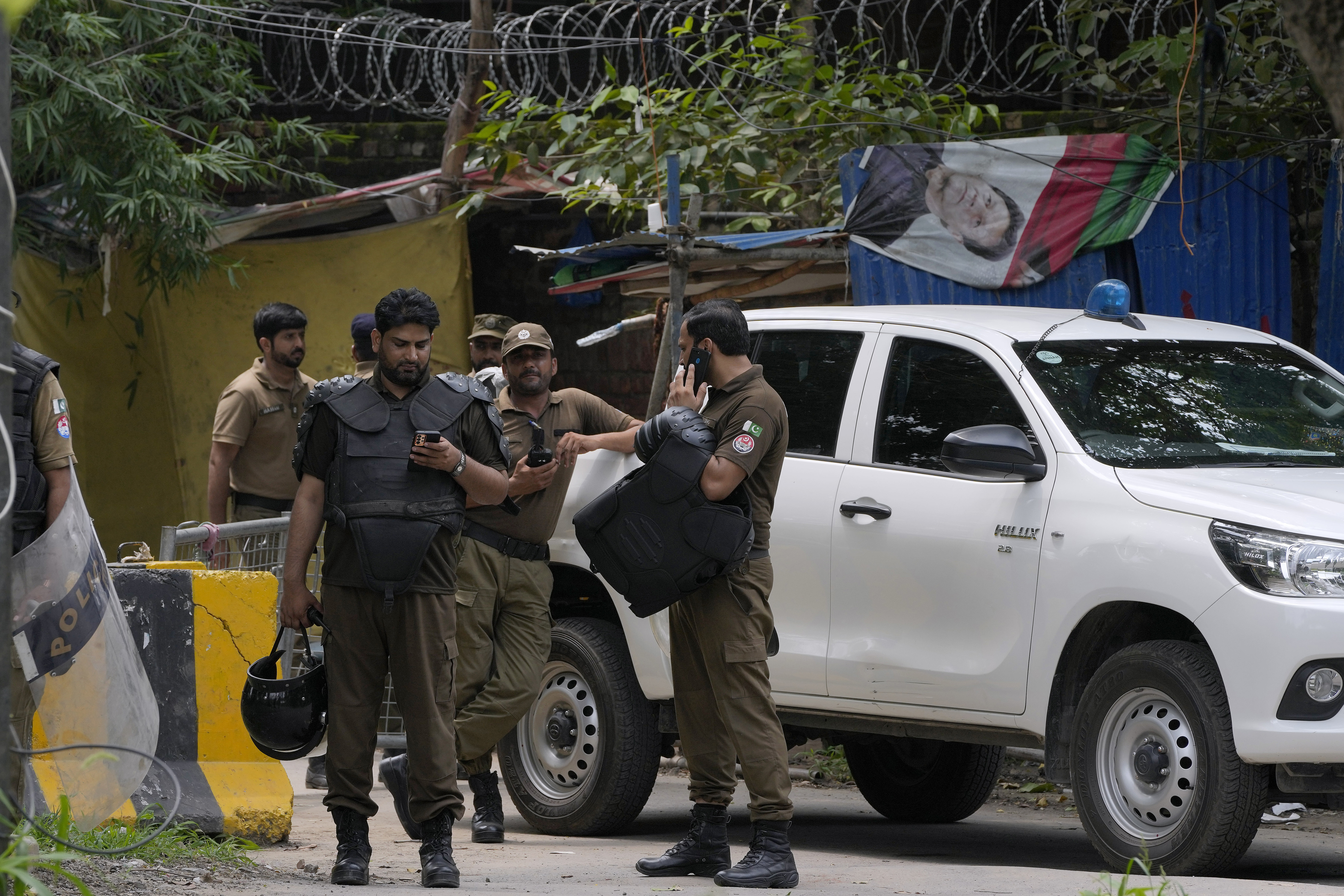 Police officers prepare to take position outside the residence of Pakistan's former Prime Minister Imran Khan