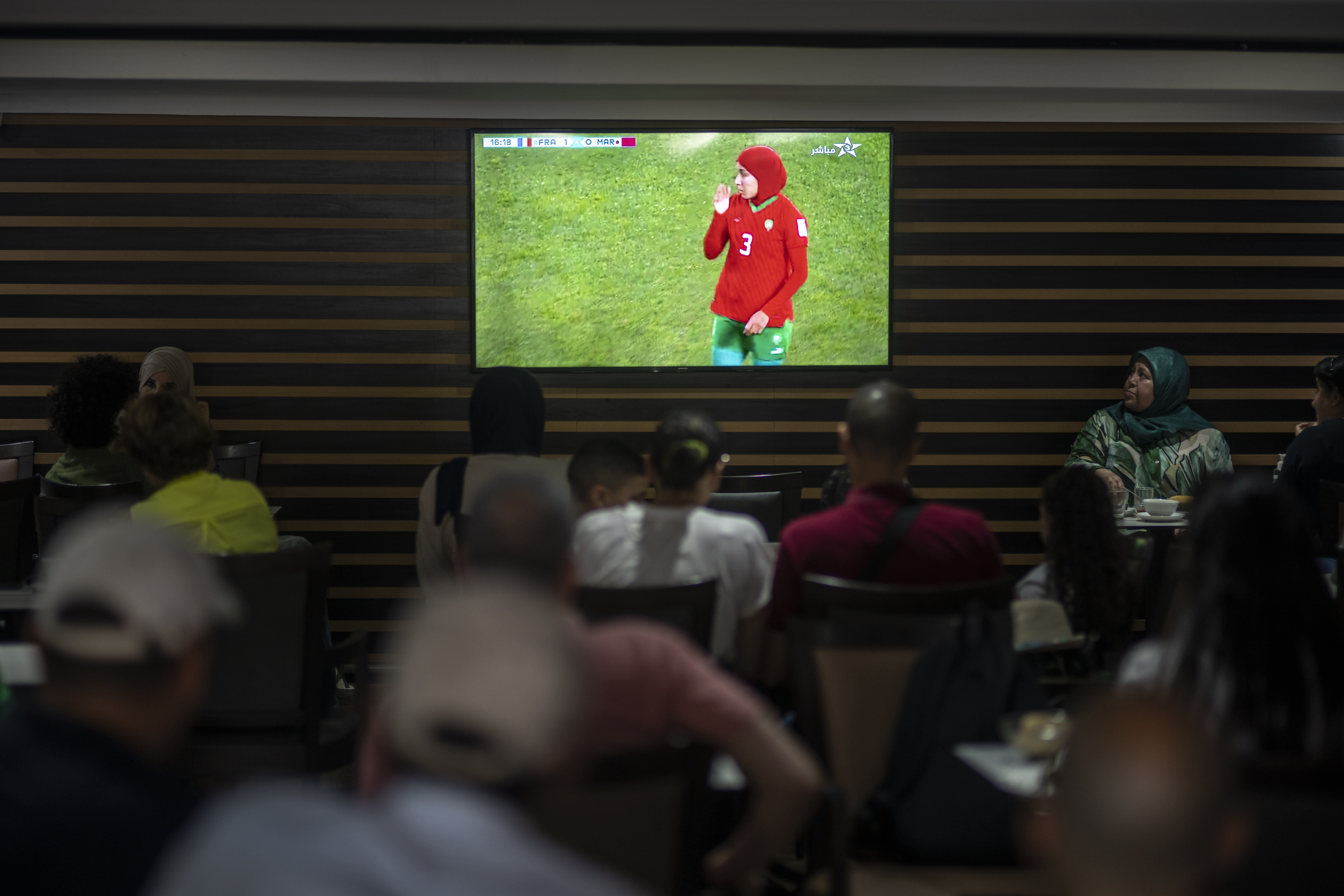 Moroccans watch a football game in a coffee shop in Rabat