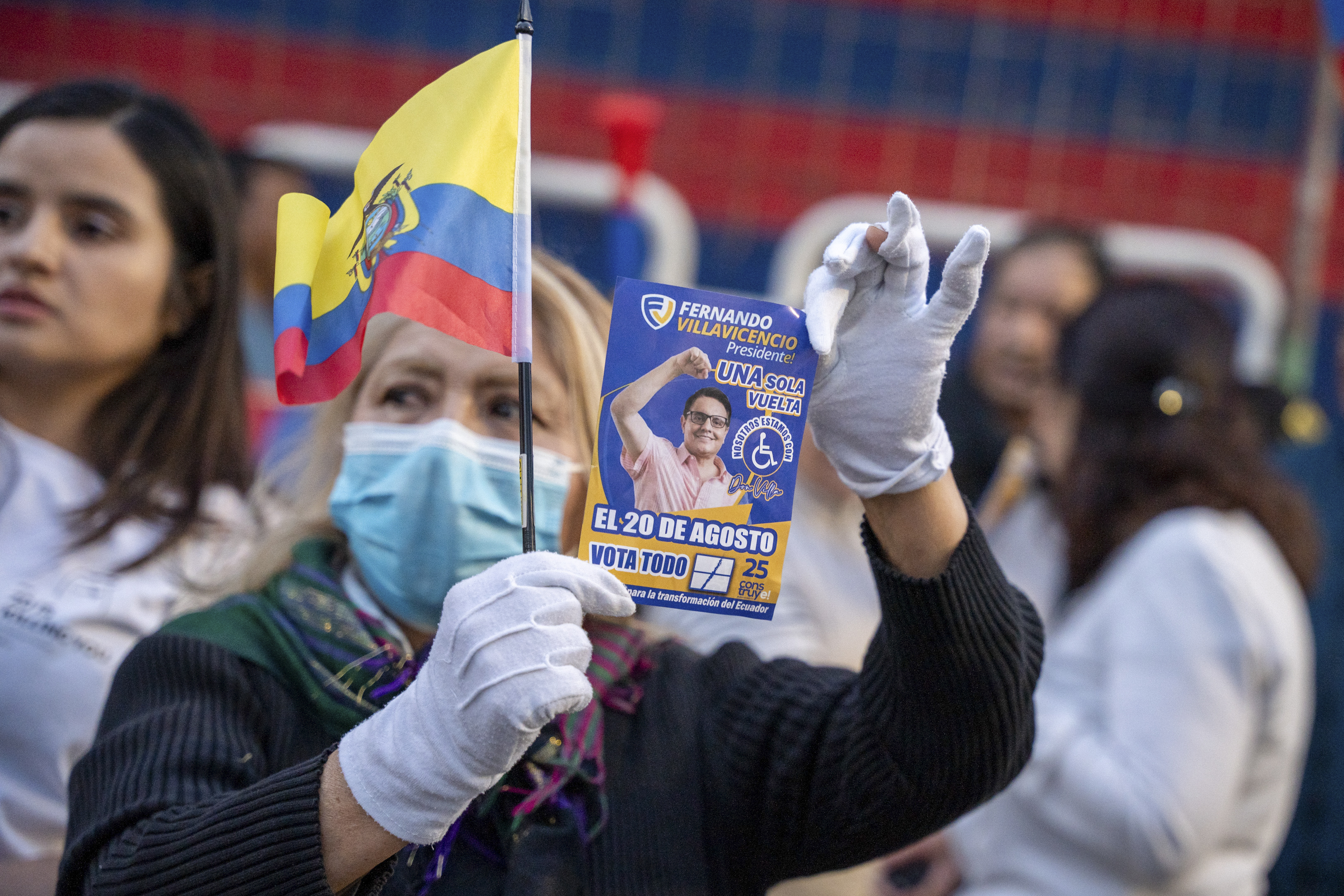 A supporter shows a flyer of Fernando Villavicencio