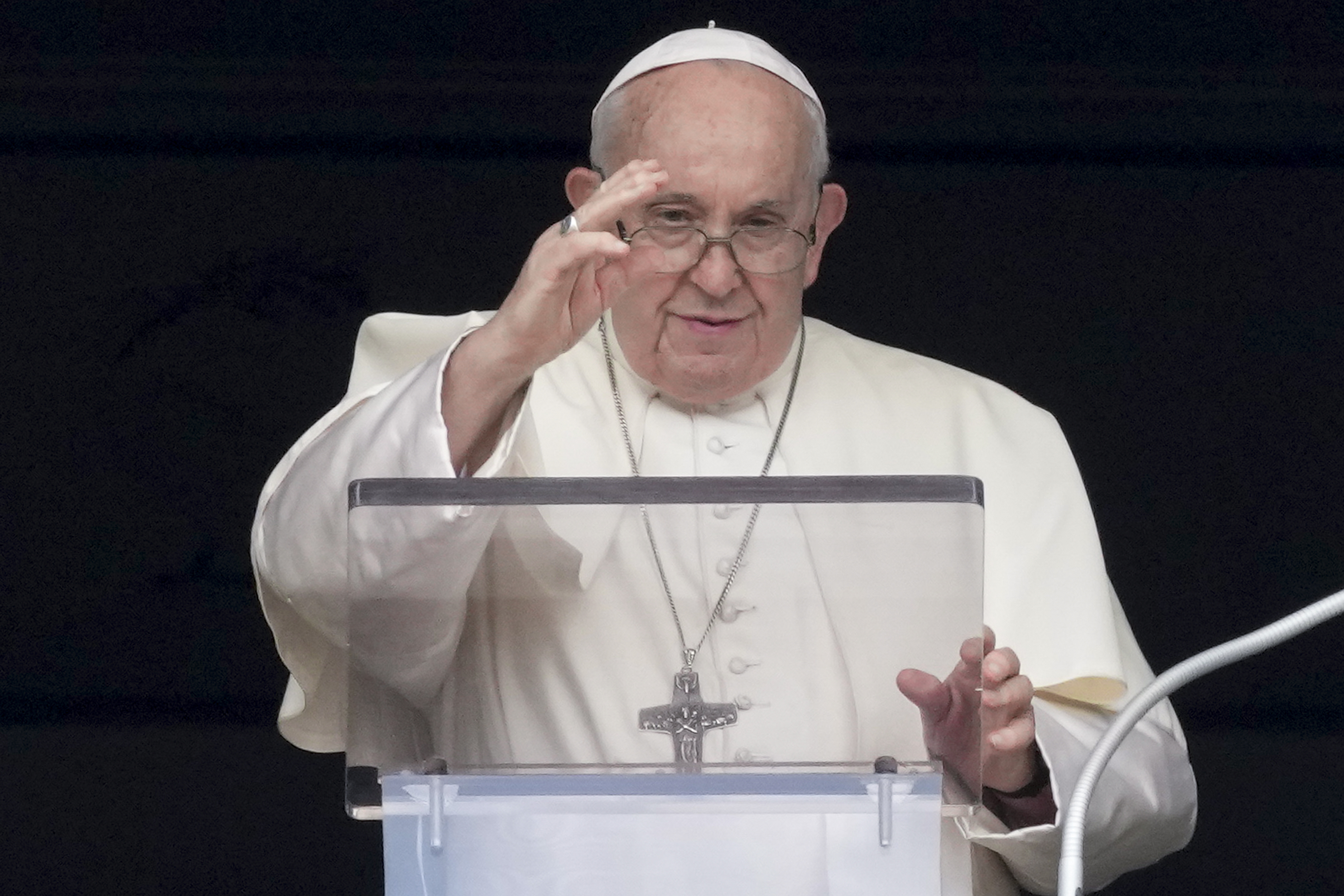 The Pope at St Peter's Square. He is giving a blessing and reciting a prayer from the window of his studio to those gathered in the square.