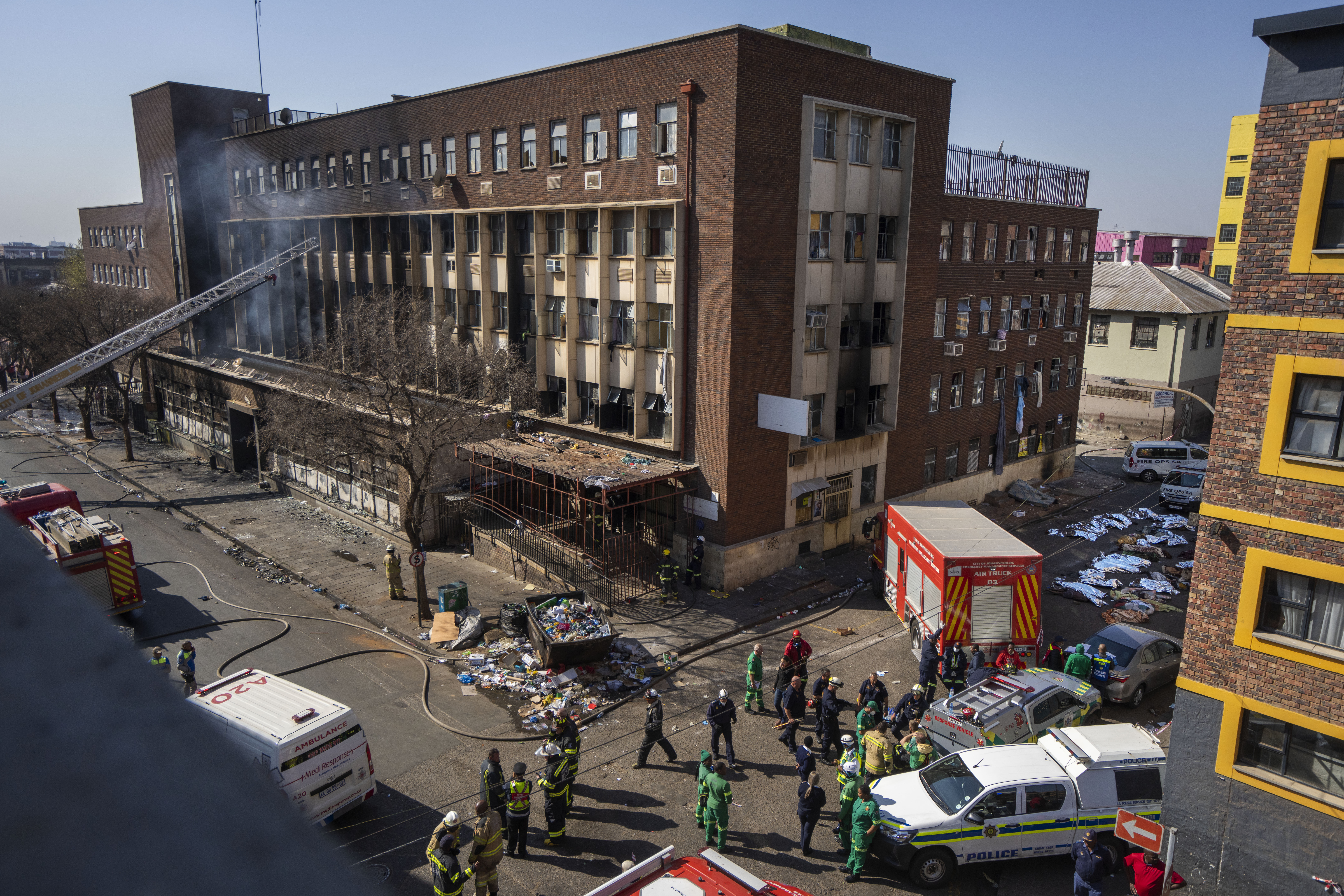 Medics and emergency works at the scene of a deadly blaze in downtown Johannesburg