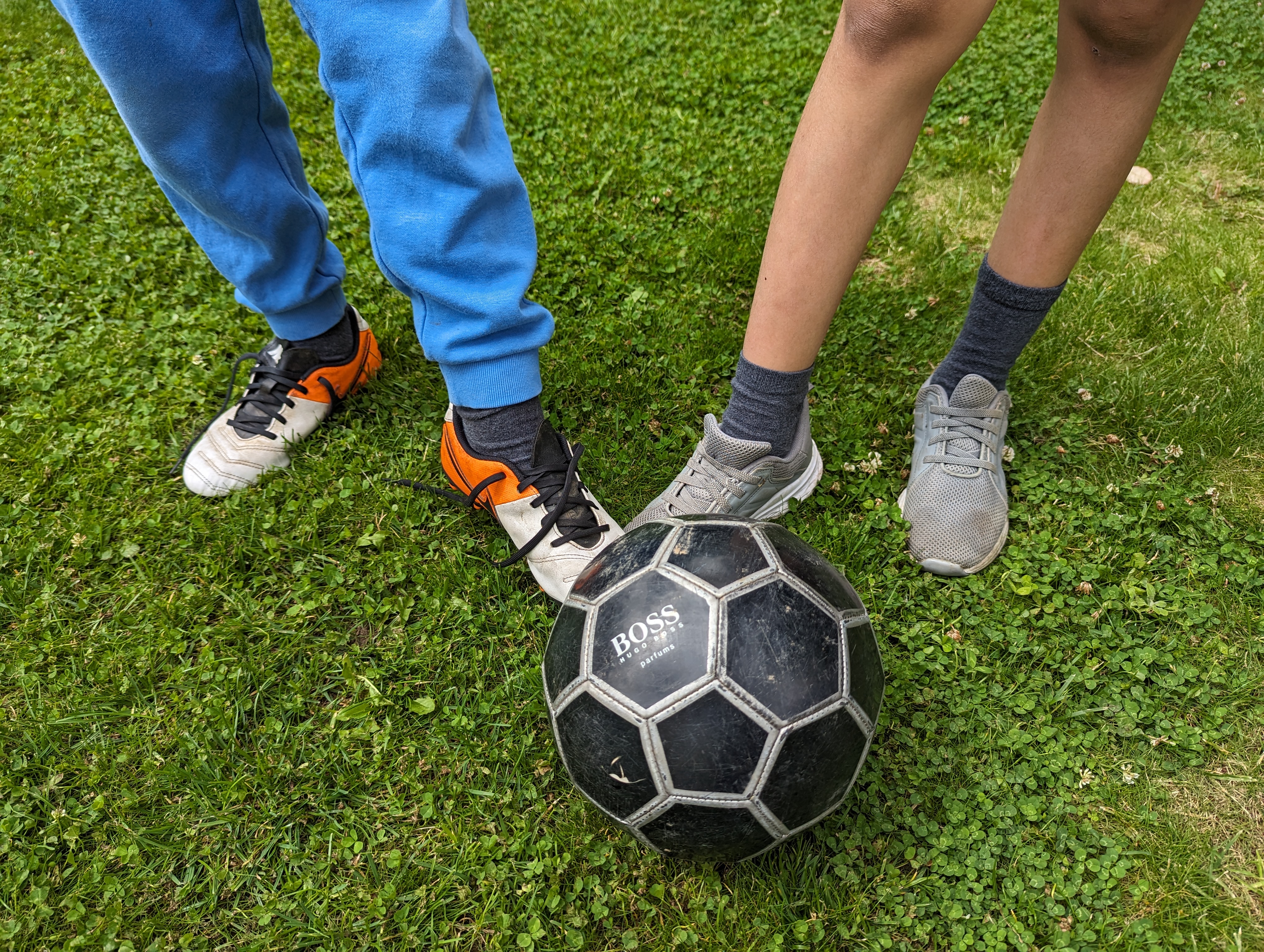 A photo of two children playing football.