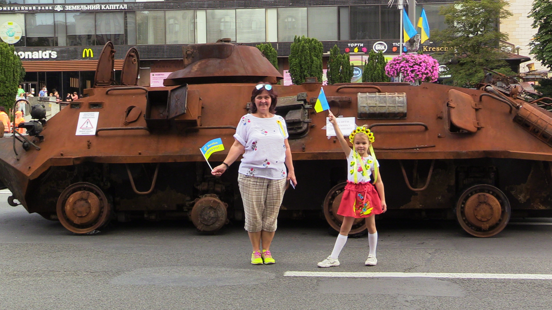 People stand in front of tank