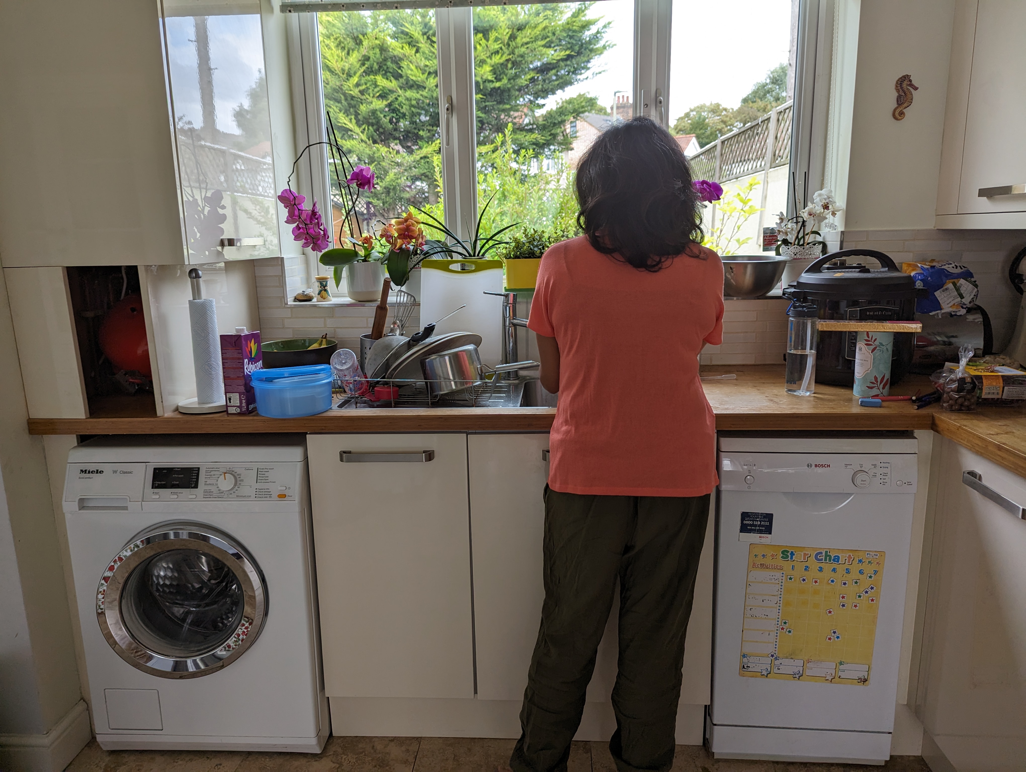 A photo of someone washing dishes.