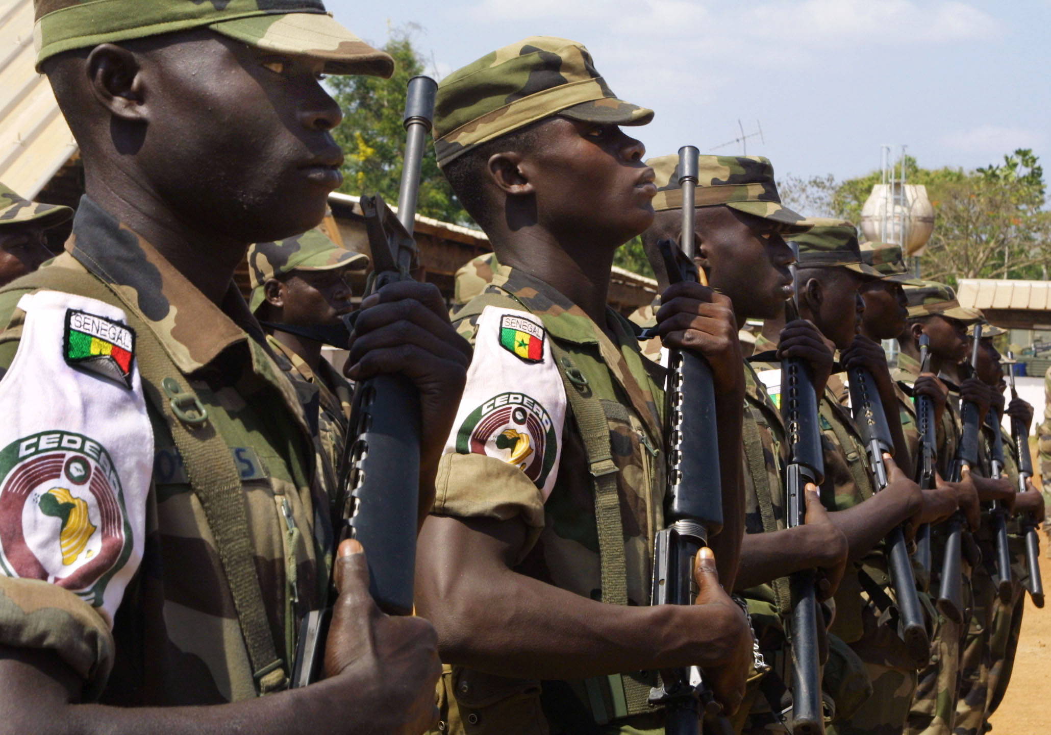 Senegalese soldiers with ECOMOG, the military arm of the Economic Community of West African States, stand guard in the village of Lomo nord, in central Ivory Coast on 14 February 2003 