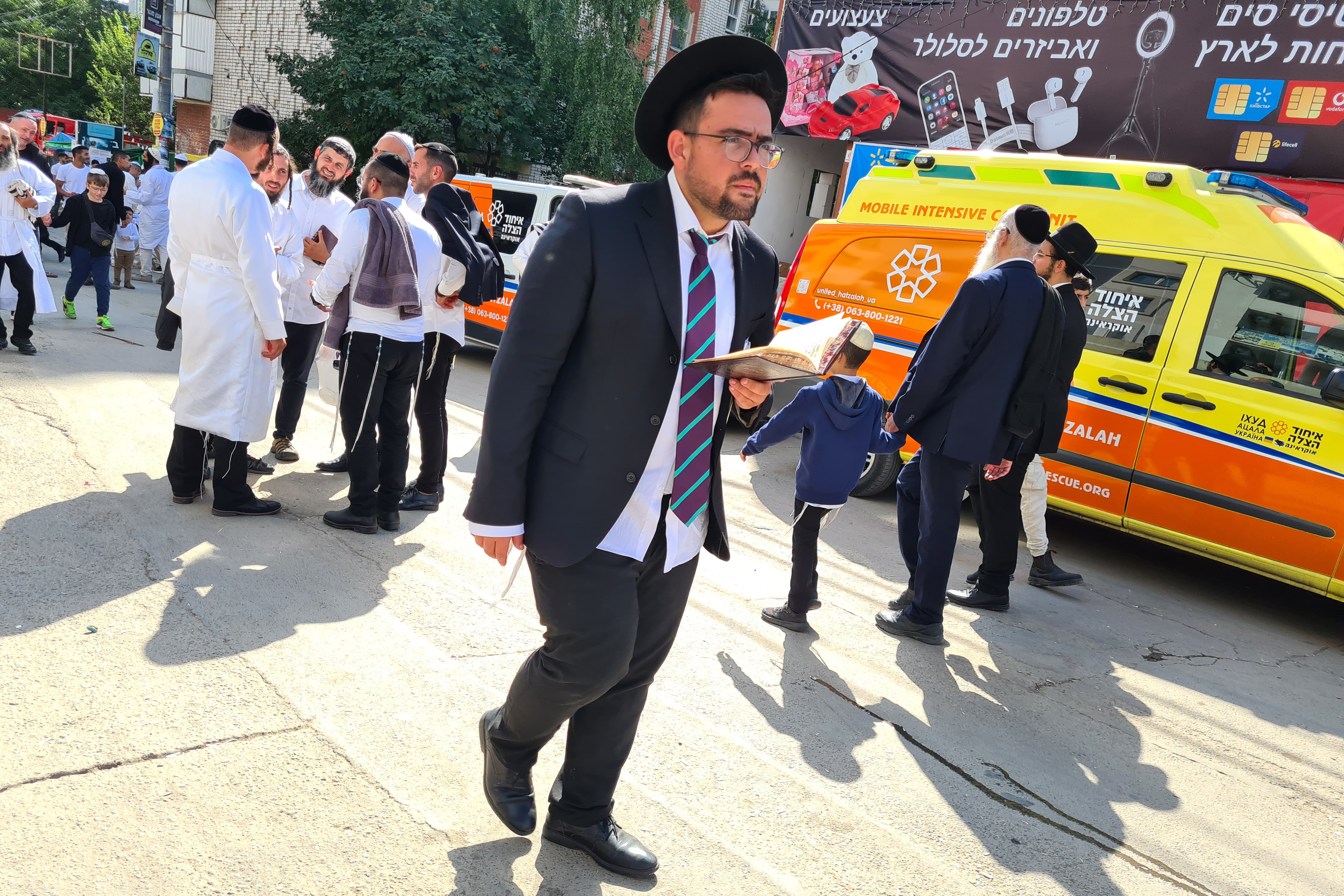 A pilgrim with a prayer book walking down the Pushkin stret in central Uman