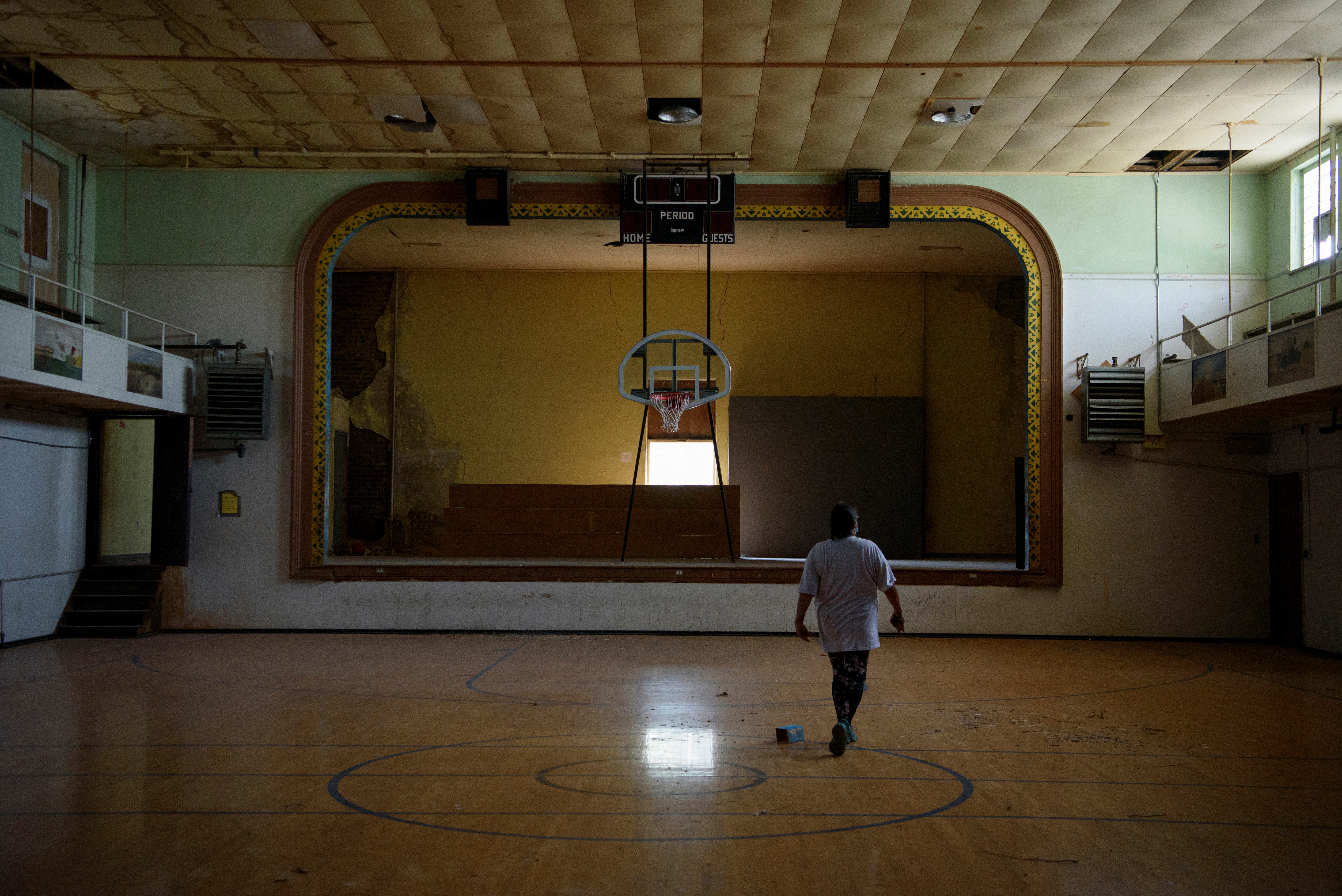 A person walks through an abandoned gym that used to be part of the former St. Paul’s Indian Mission School during a tour of the school grounds in Marty, South Dakota, US