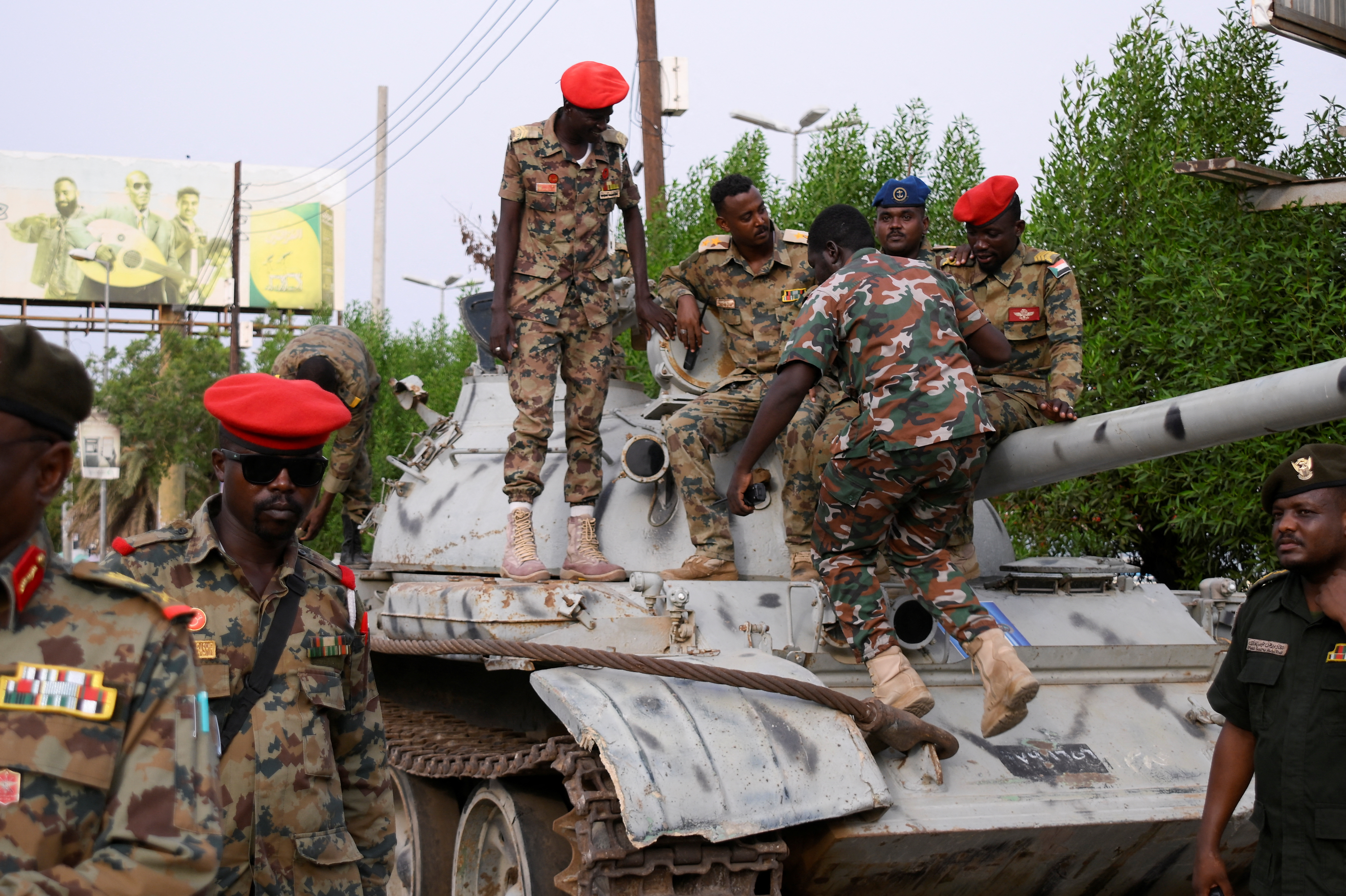 Members of military armed guard are seen around a tank after the arrival of Sudan's General Abdel Fattah al-Burhan in the military airport of Port Sudan on his first trip away following the crisis in Sudan's capital Khartoum since an internal conflict broke out, in the city of Port Sudan