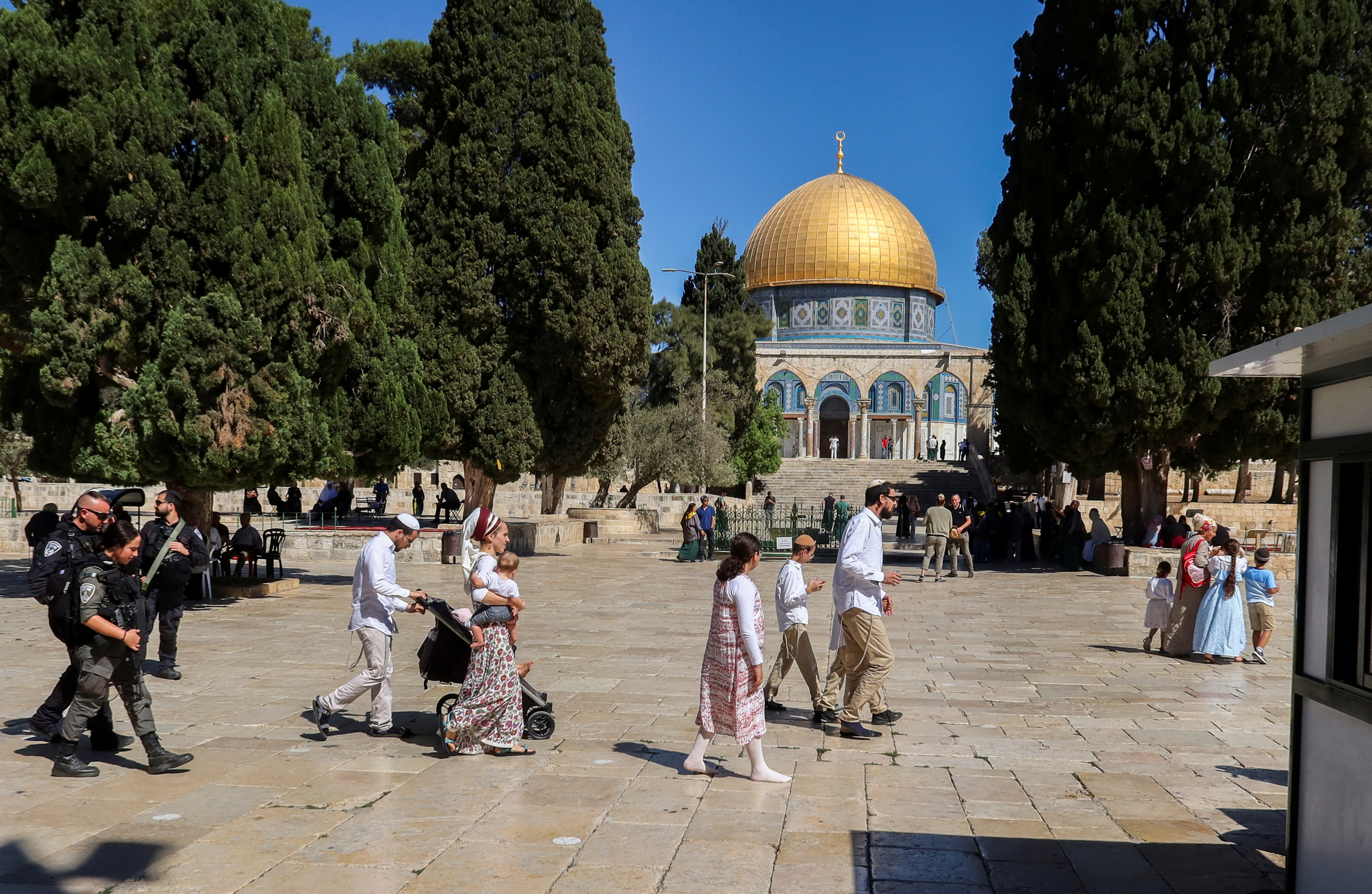 Israeli police escort visitors as they tour the Al-Aqsa compound