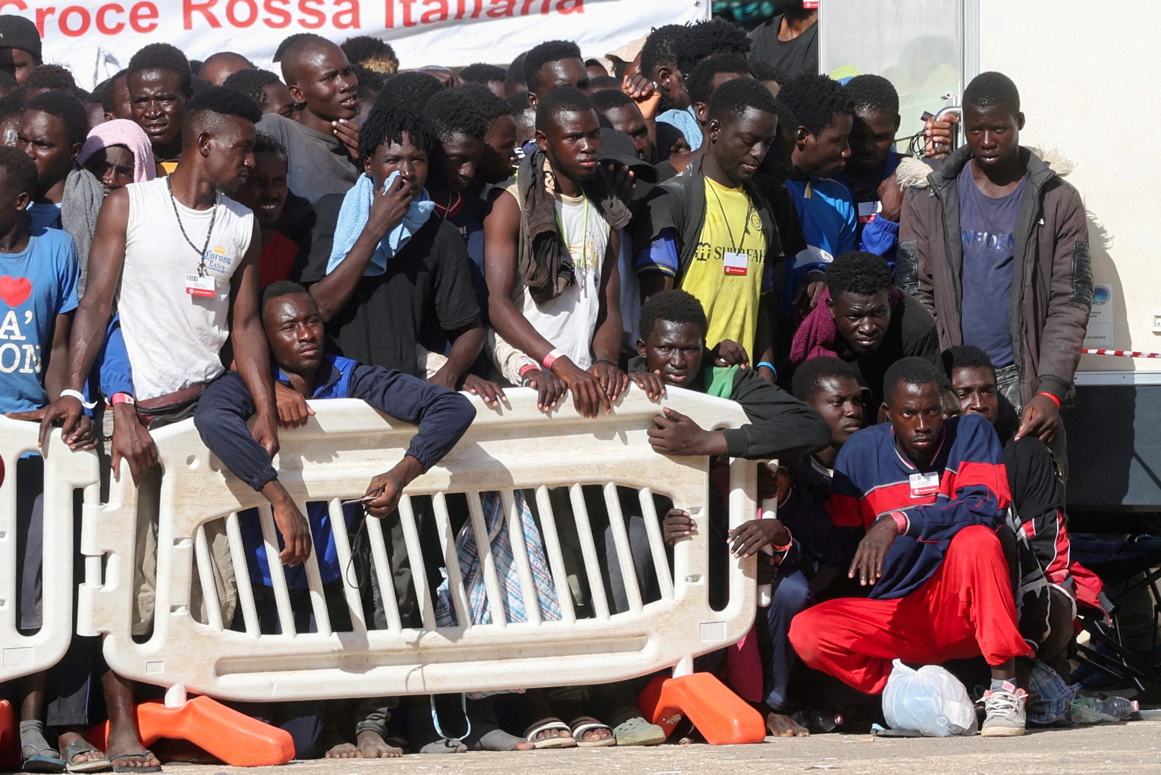 Migrants gather at the hotspot, a reception centre for migrants, ahead of European Commission President Ursula von der Leyen and Italian Prime Minister Giorgia Meloni's visit to the Sicilian island of Lampedusa, Italy