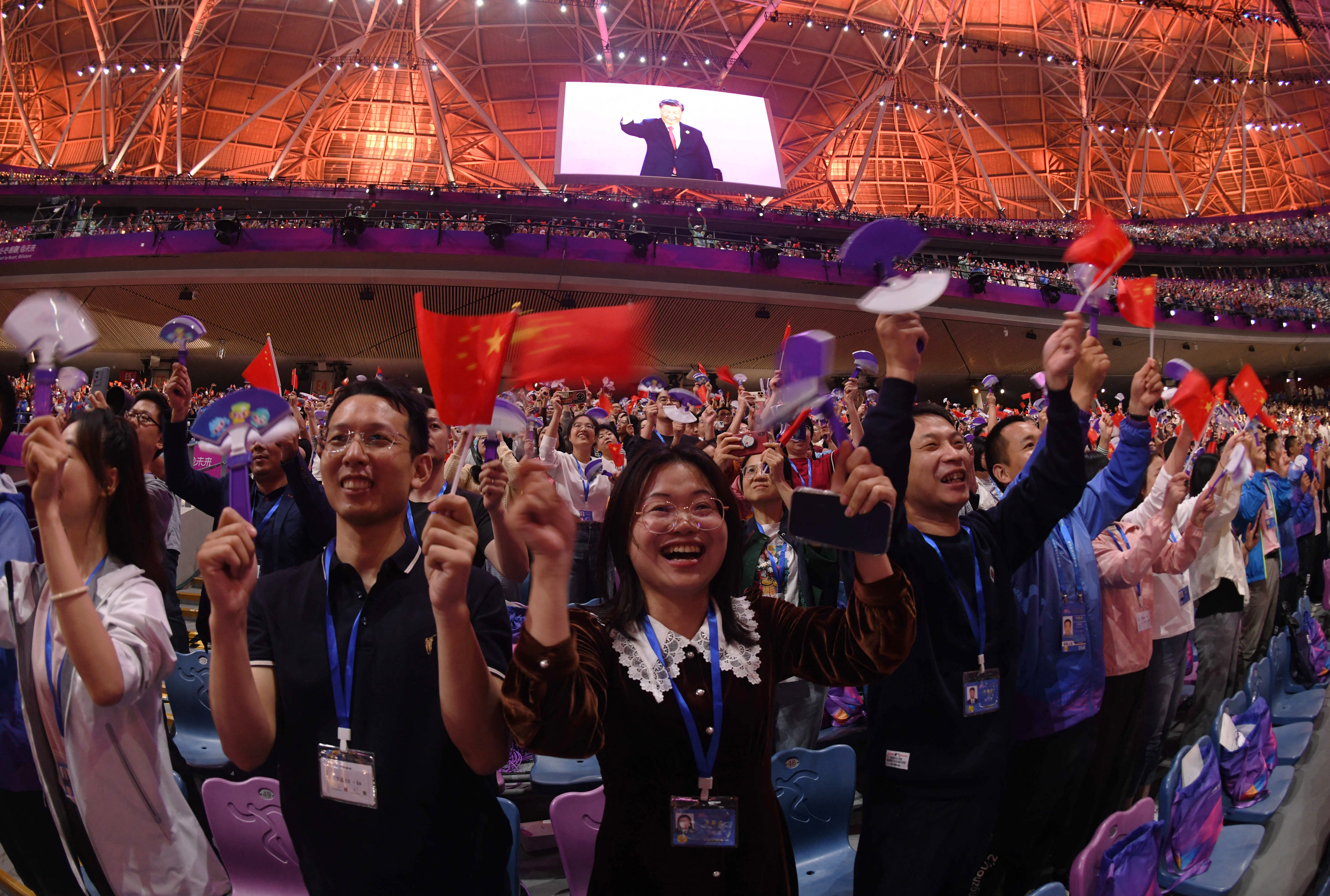 Asian Games - Hangzhou 2022 - Opening Ceremony - Hangzhou Olympic Sports Center Stadium, Hangzhou, China - September 23, 2023 People wave Chinese flags at the Opening Ceremony Reuters/Weixiang Lim